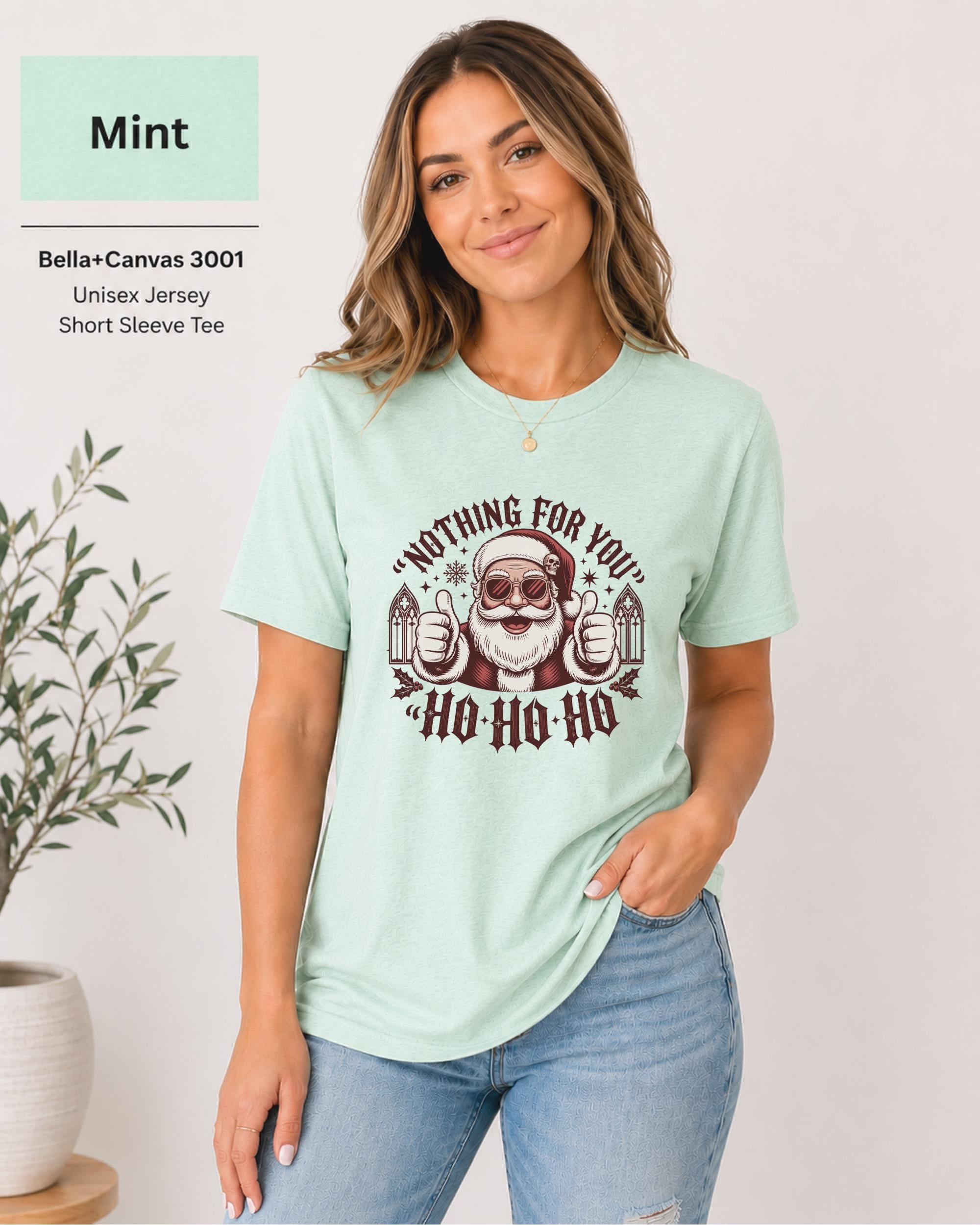 Mint unisex holiday t-shirt with cathedral accents, stars, snowflakes, and cheeky Santa design.