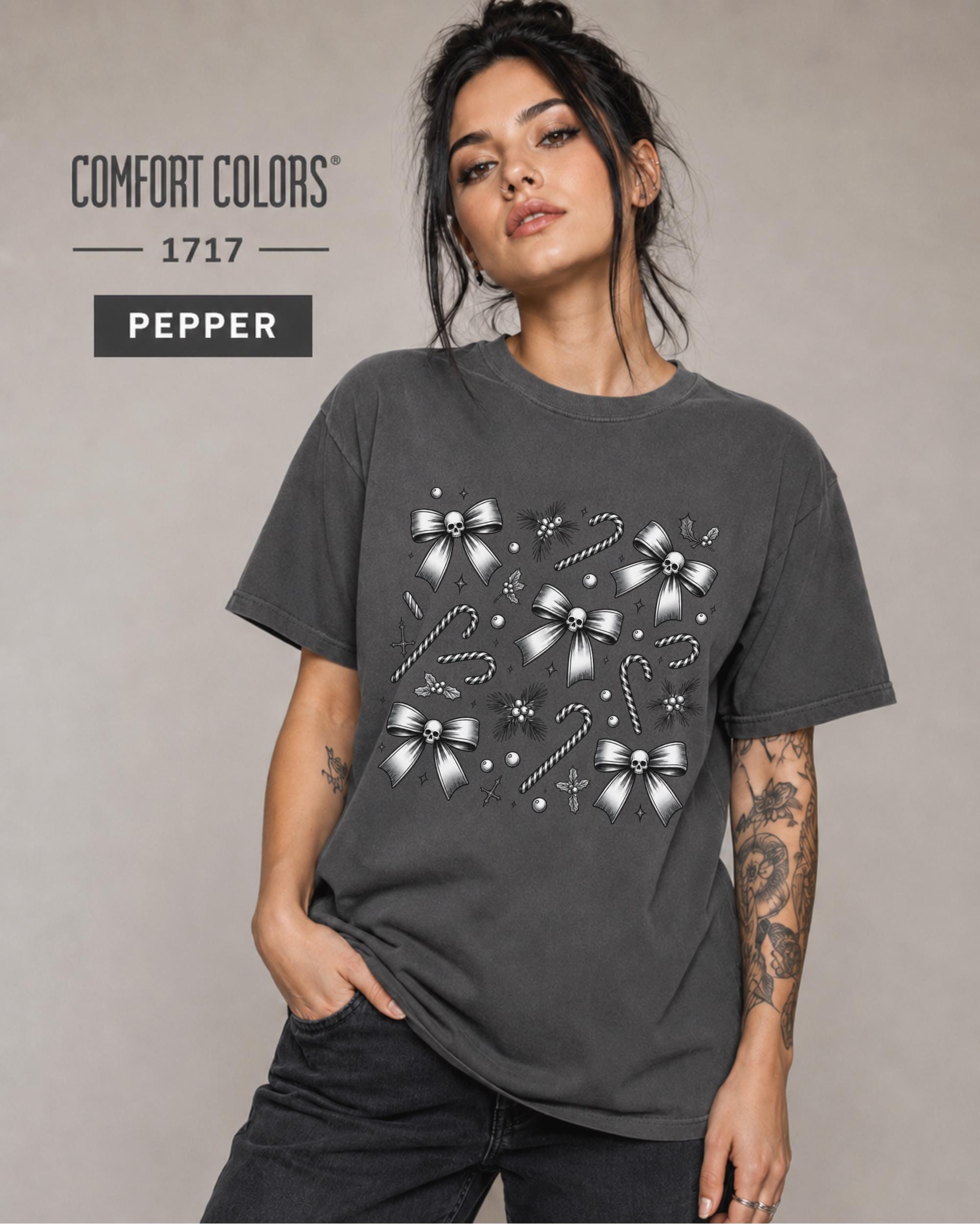 Woman wearing a Pepper Comfort Colors 1717 gothic Christmas shirt with skull bows and candy cane artwork.