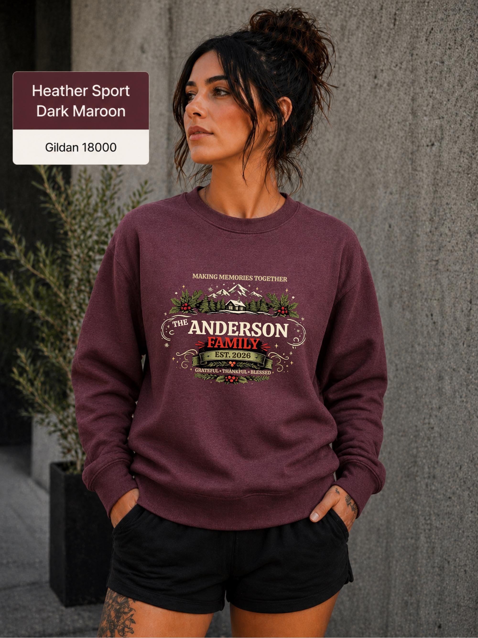 Custom last name holiday crewneck featuring snowy mountains, evergreen trees, cabin, holly, and berries.