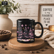 Black coffee mug featuring skull Christmas trees and festive pink decorations.
