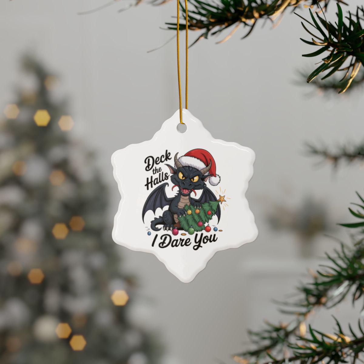 Snowflake ceramic ornament featuring a Santa hat dragon and Deck the Halls I Dare You holiday quote.