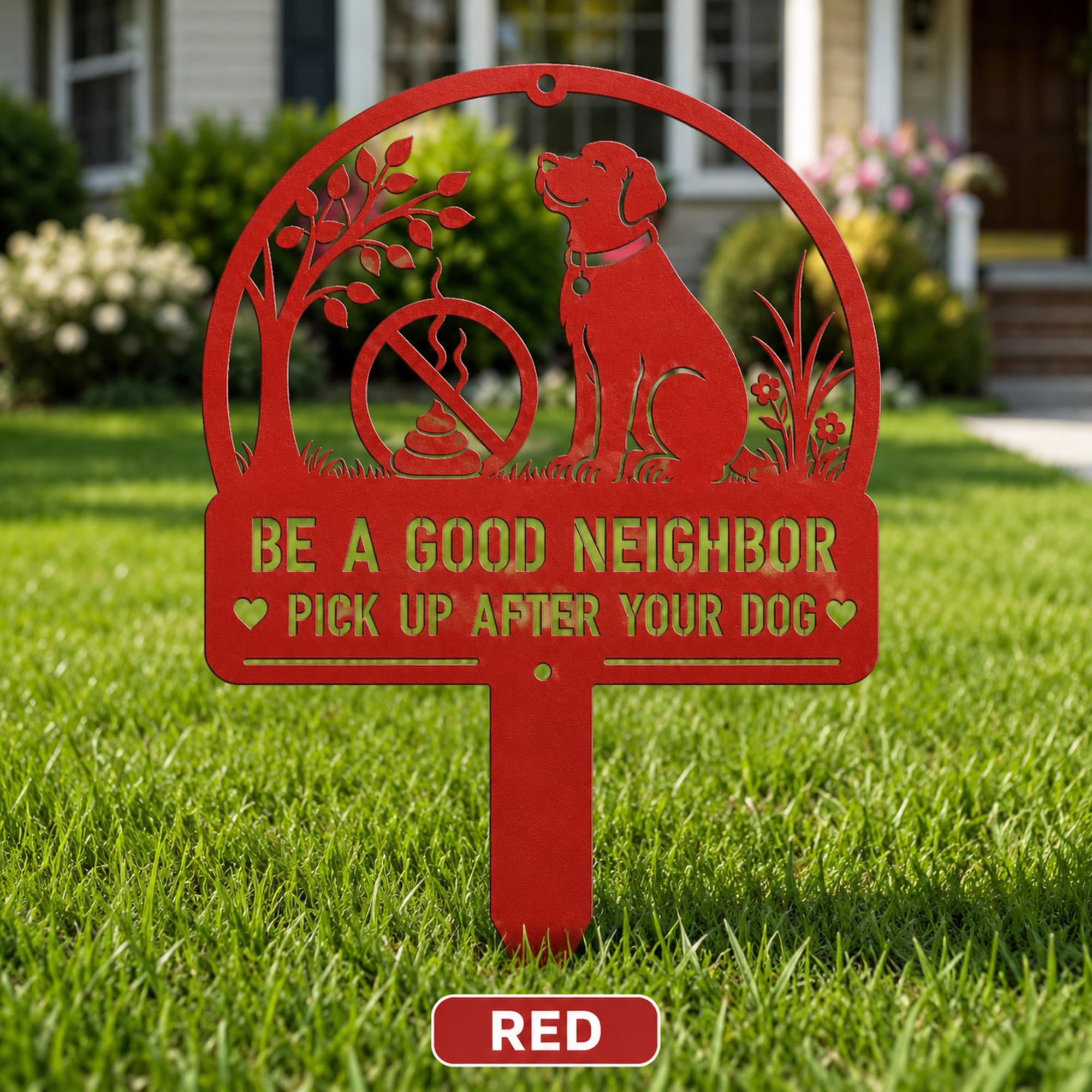 Red metal yard stake sign with dog silhouette and the text Be a Good Neighbor Pick Up After Your Dog displayed on a front lawn.