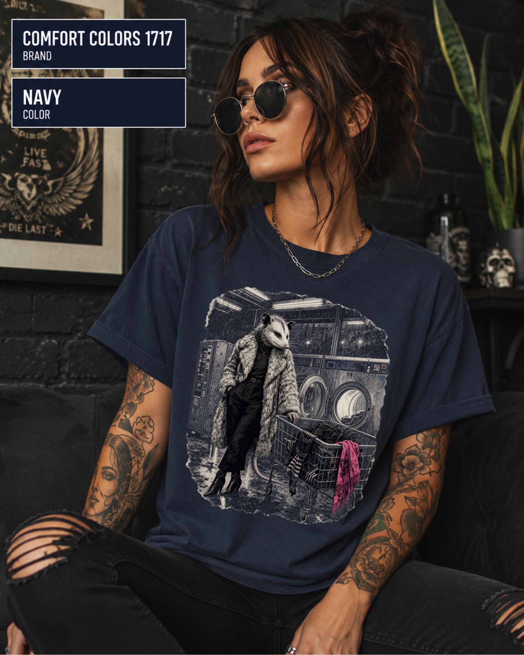 Vintage-style possum shirt with distressed black-and-white artwork and bright pink clothing accent.