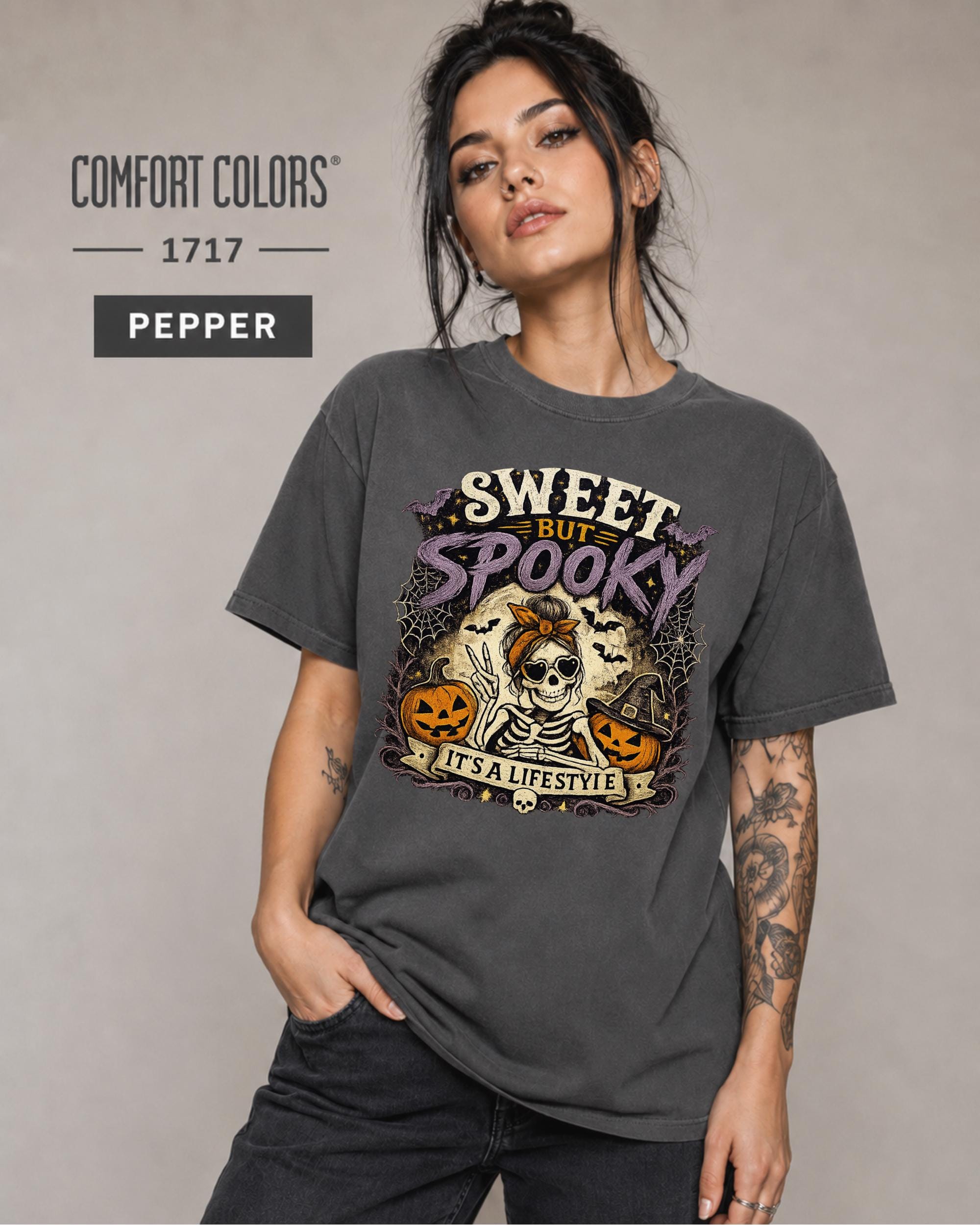 Woman wearing a Pepper Comfort Colors 1717 shirt featuring a Sweet but Spooky skeleton Halloween design.