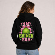 Cotton Heritage M2580 hoodie featuring a pink and green holiday character design with In My Grinch Era text on the front.