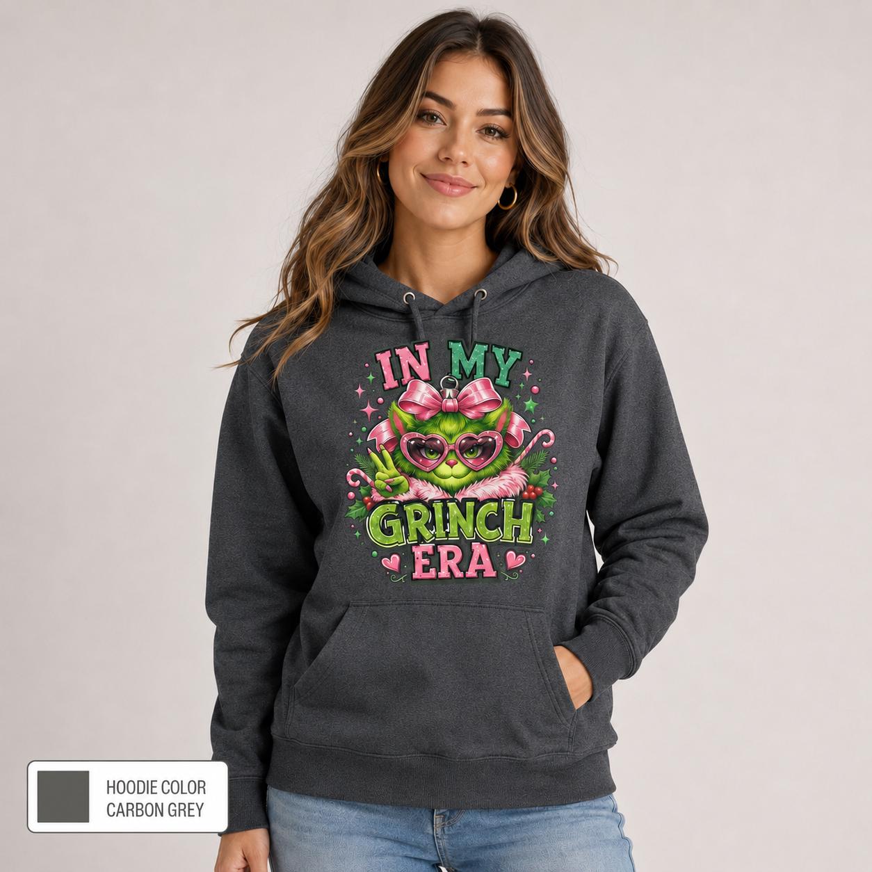 Female model wearing a carbon grey hoodie with a vibrant pink and green holiday design and color label shown.