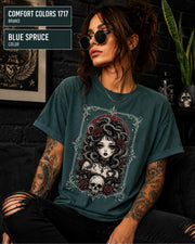 Woman wearing a Blue spruce Comfort Colors 1717 T-shirt featuring a gothic Medusa-inspired woman with snakes, dark roses, ornate framing, and a skull design.