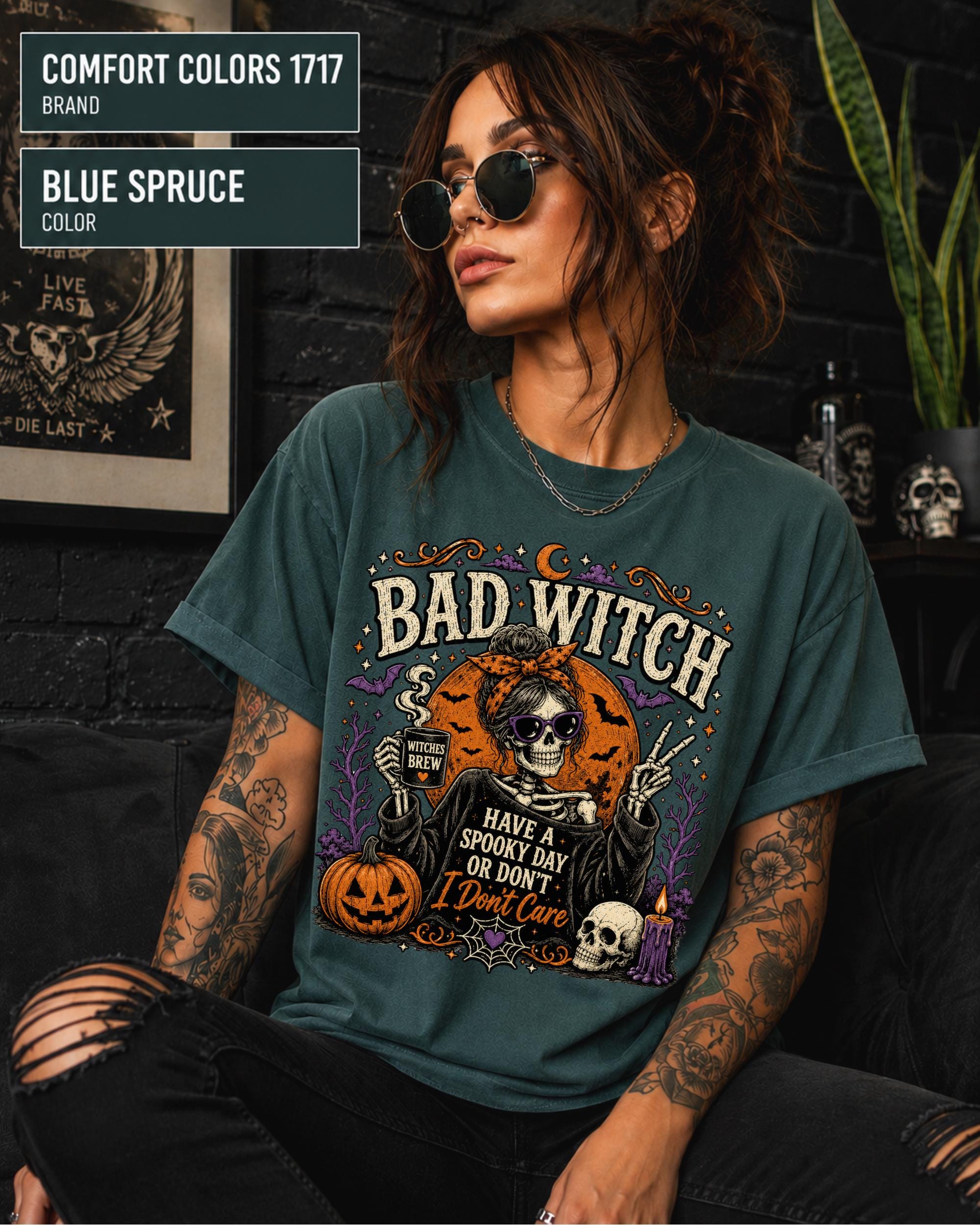 Comfort Colors Blue spruce tee featuring pumpkins, bats, skulls, moon, candle, and cobweb details.