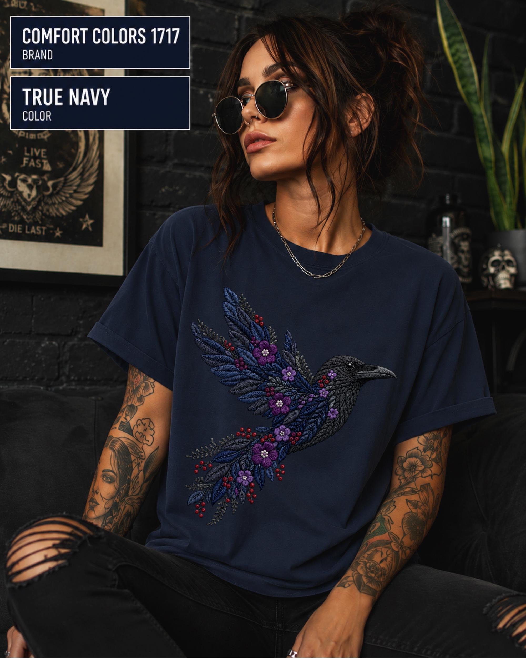 True Navy Comfort Colors 1717 t-shirt featuring a black raven graphic with purple flowers and blue feather details in a gothic botanical style.