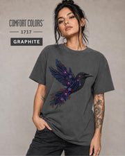 Graphite Comfort Colors 1717 t-shirt featuring a black raven graphic with purple flowers and blue feather details in a gothic botanical style.