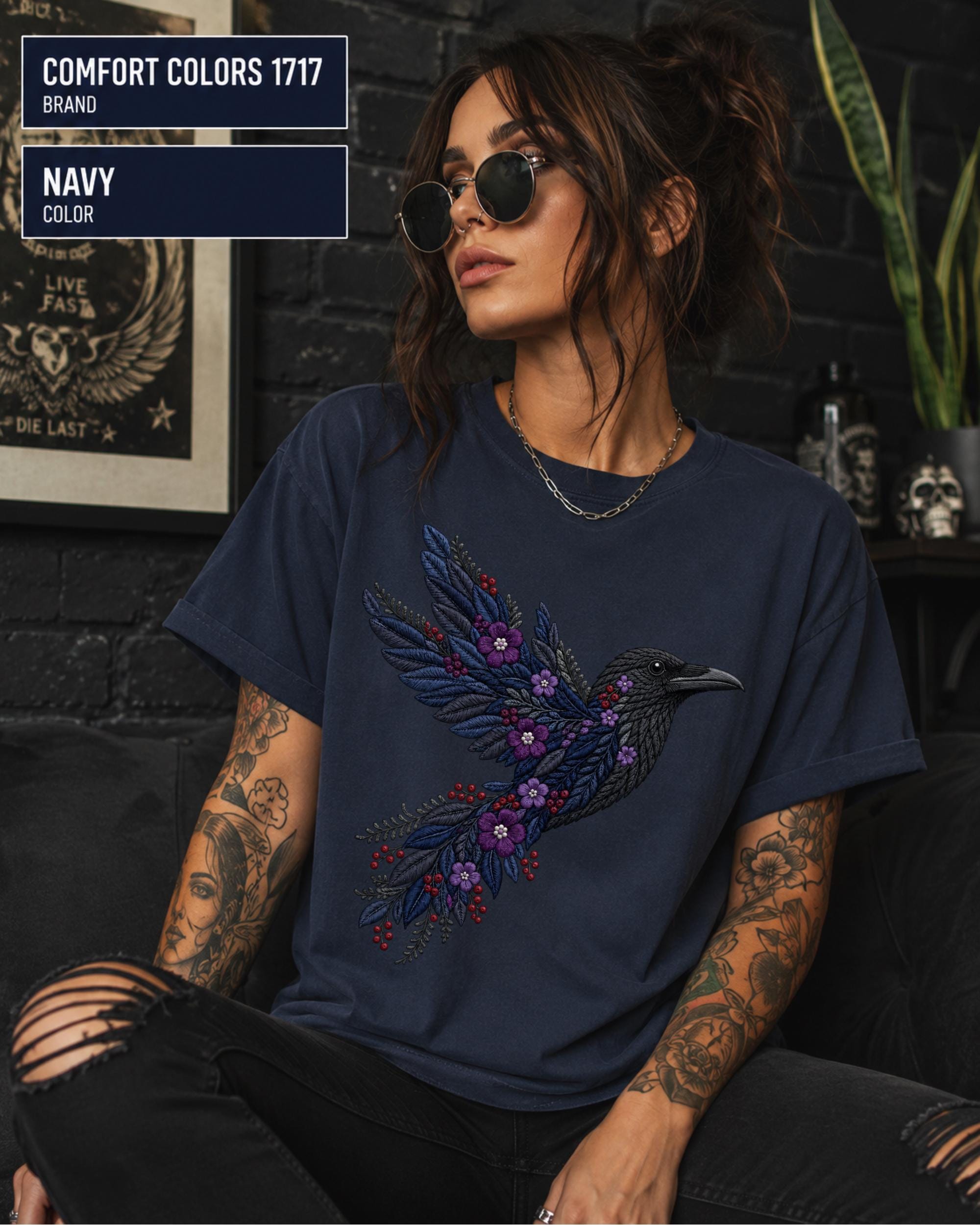 Navy Comfort Colors 1717 t-shirt featuring a black raven graphic with purple flowers and blue feather details in a gothic botanical style.
