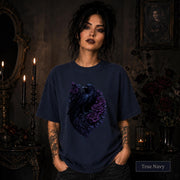 Dark romance graphic featuring a blue-black raven framed by rich purple blooms.
