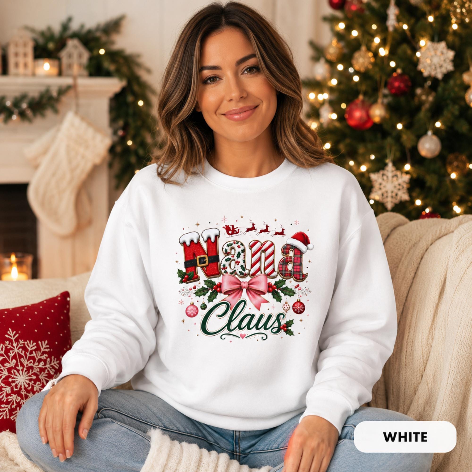 Female model wearing an white Comfort Colors crewneck featuring a festive “Nana Claus” Christmas design with a pink bow, holly, ornaments, and holiday lettering.