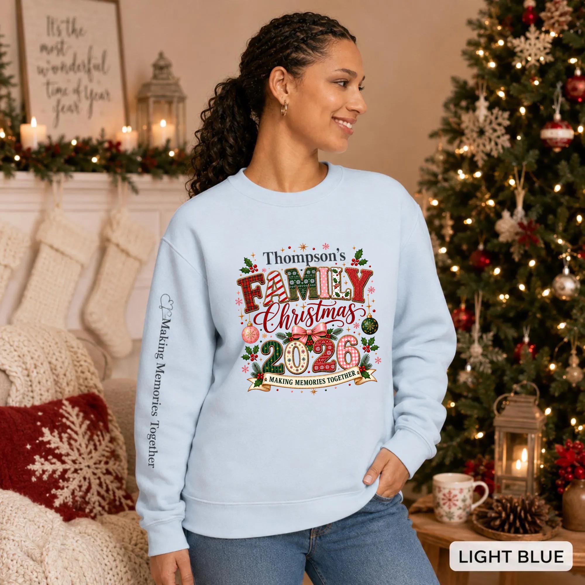 Light blue Christmas crewneck featuring a personalized Thompson’s Family Christmas 2026 design with festive lettering and sleeve text.