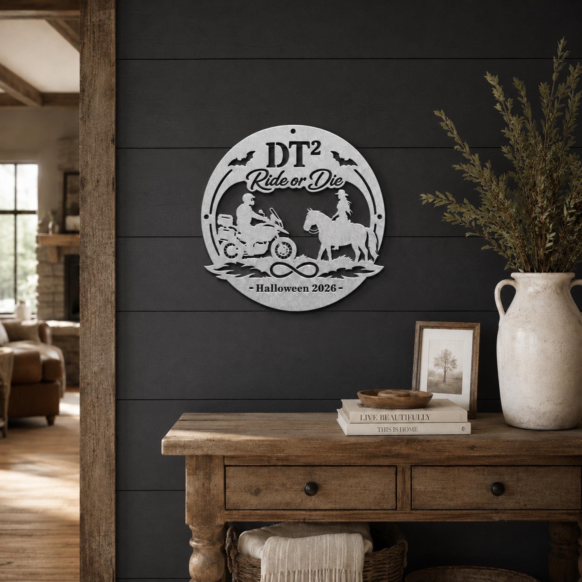 Personalized silver “Ride or Die” Halloween metal sign with motorcycle rider, horseback rider, bats, infinity symbol, custom initials, and year displayed on a decorated front porch.