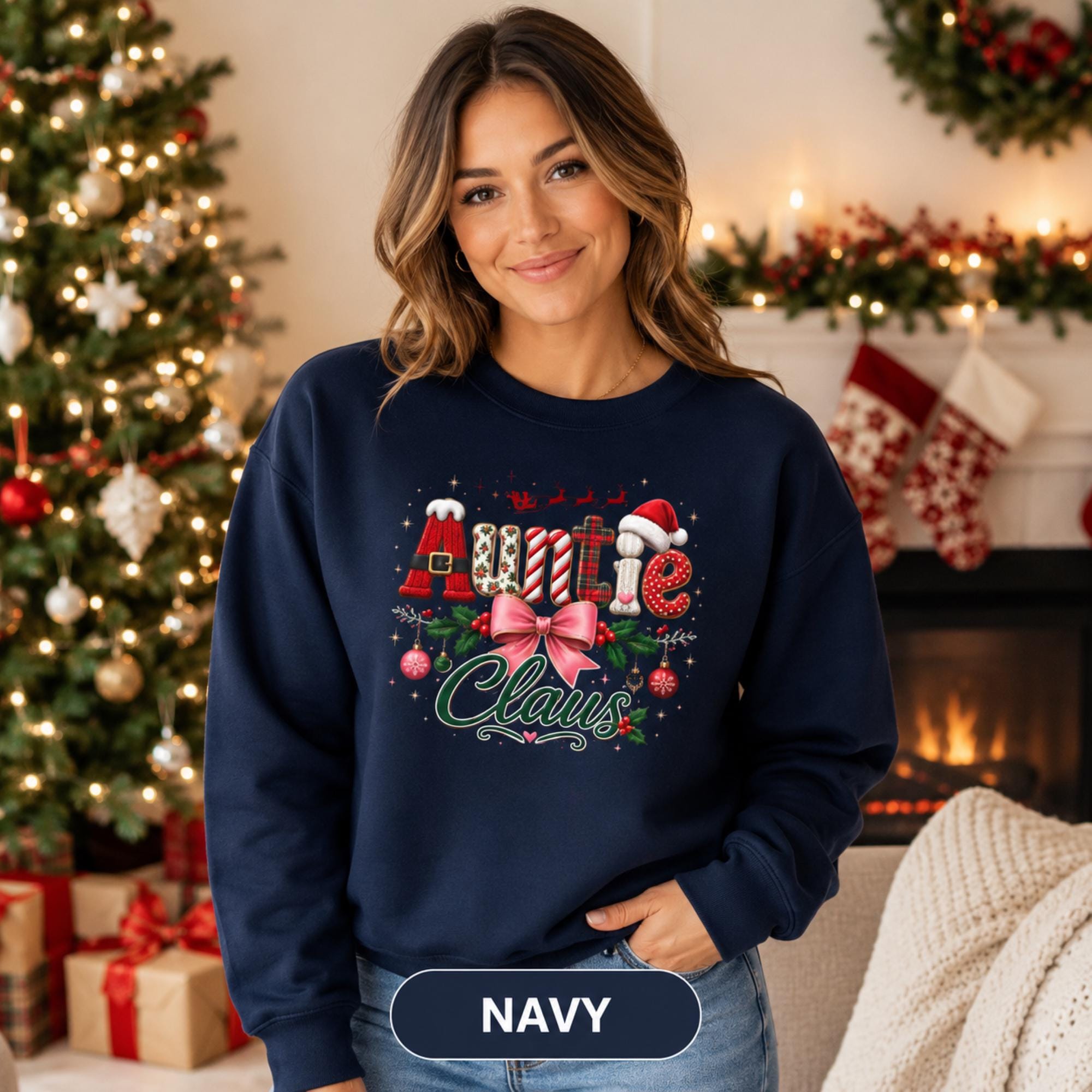 Holiday crewneck with Auntie Claus design shown in navy against a decorated Christmas tree background.