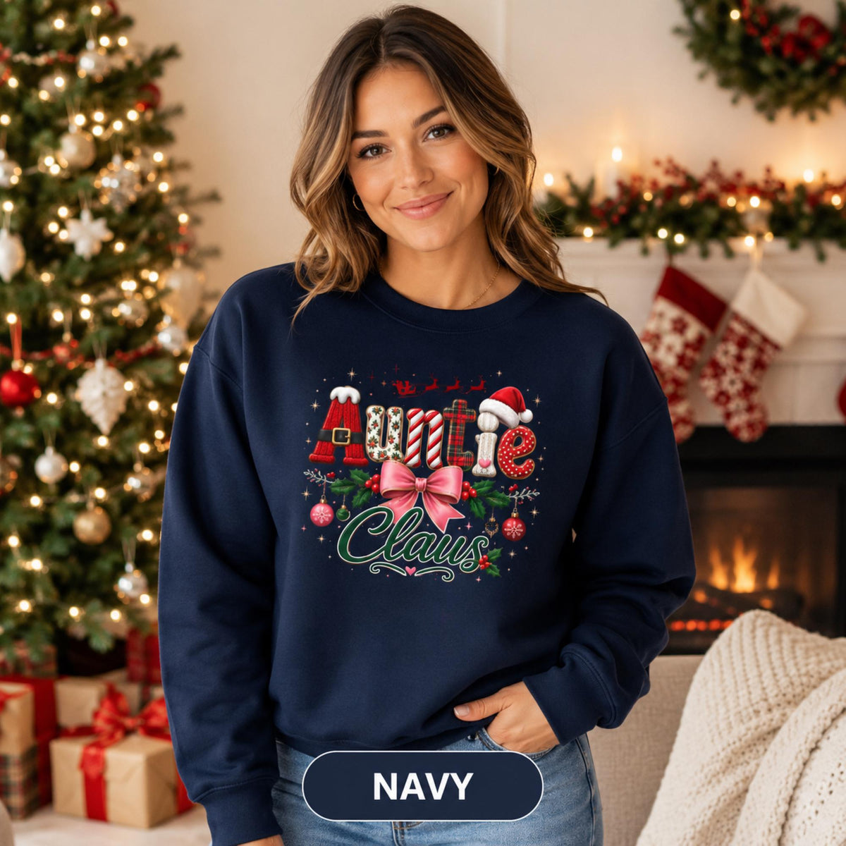 Holiday crewneck with Auntie Claus design shown in navy against a decorated Christmas tree background.