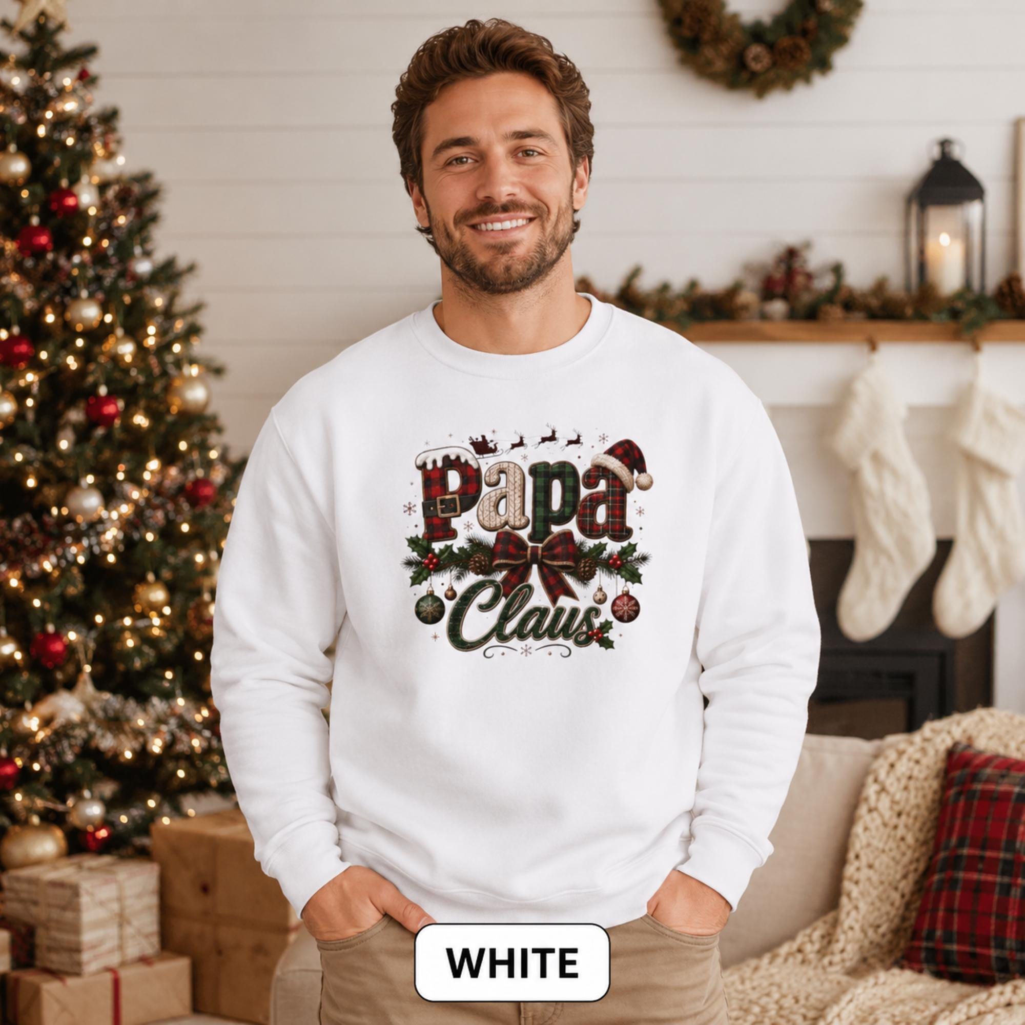 Man wearing a white Papa Claus Christmas sweatshirt with festive plaid lettering, holly, ornaments, and Santa hat.
