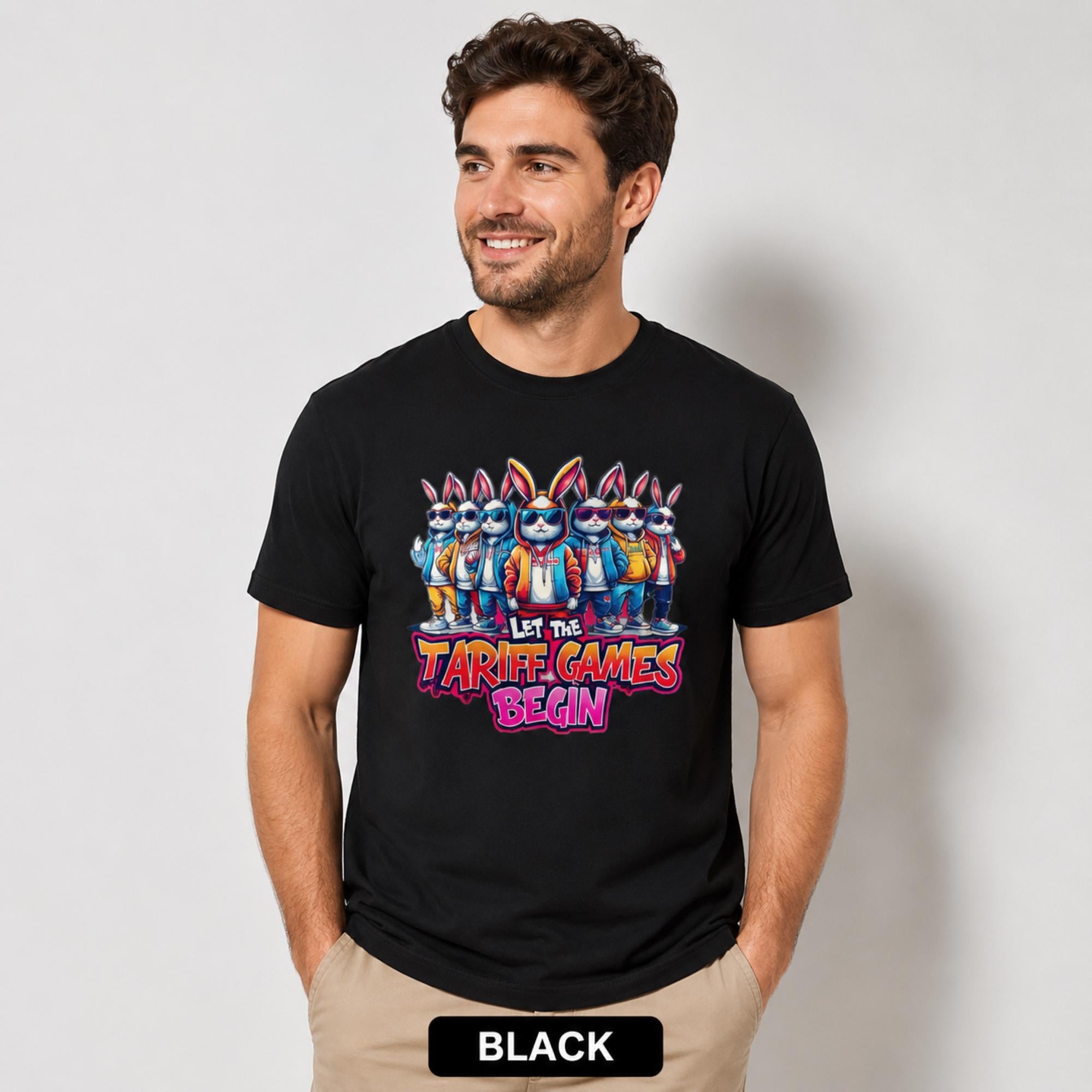 Male model wearing a black T-shirt featuring stylish cartoon rabbits and bold “Let the Tariff Games Begin” text.