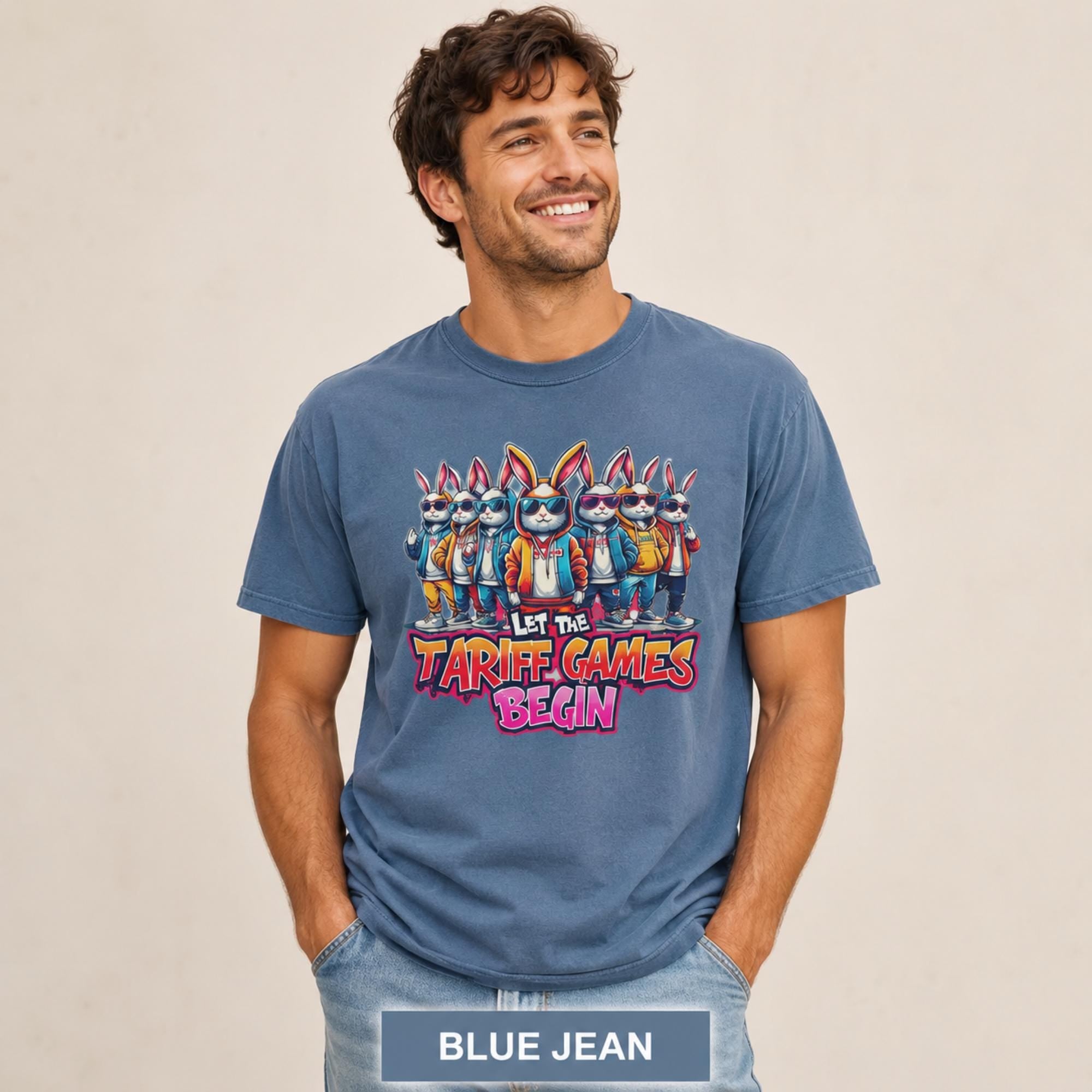 Male model wearing a blue jean T-shirt featuring stylish cartoon rabbits and bold “Let the Tariff Games Begin” text.