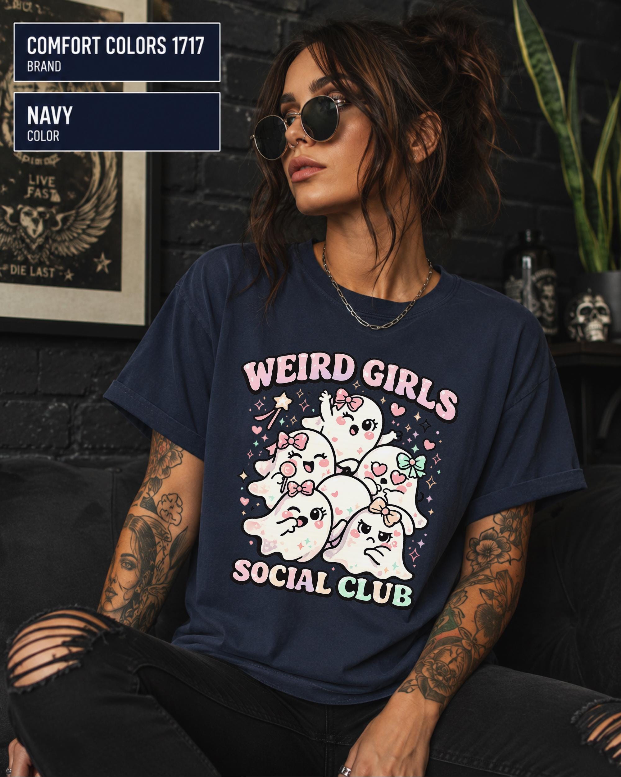 Spooky cute Halloween shirt with Weird Girls Social Club lettering, hearts, stars, and ghost artwork.