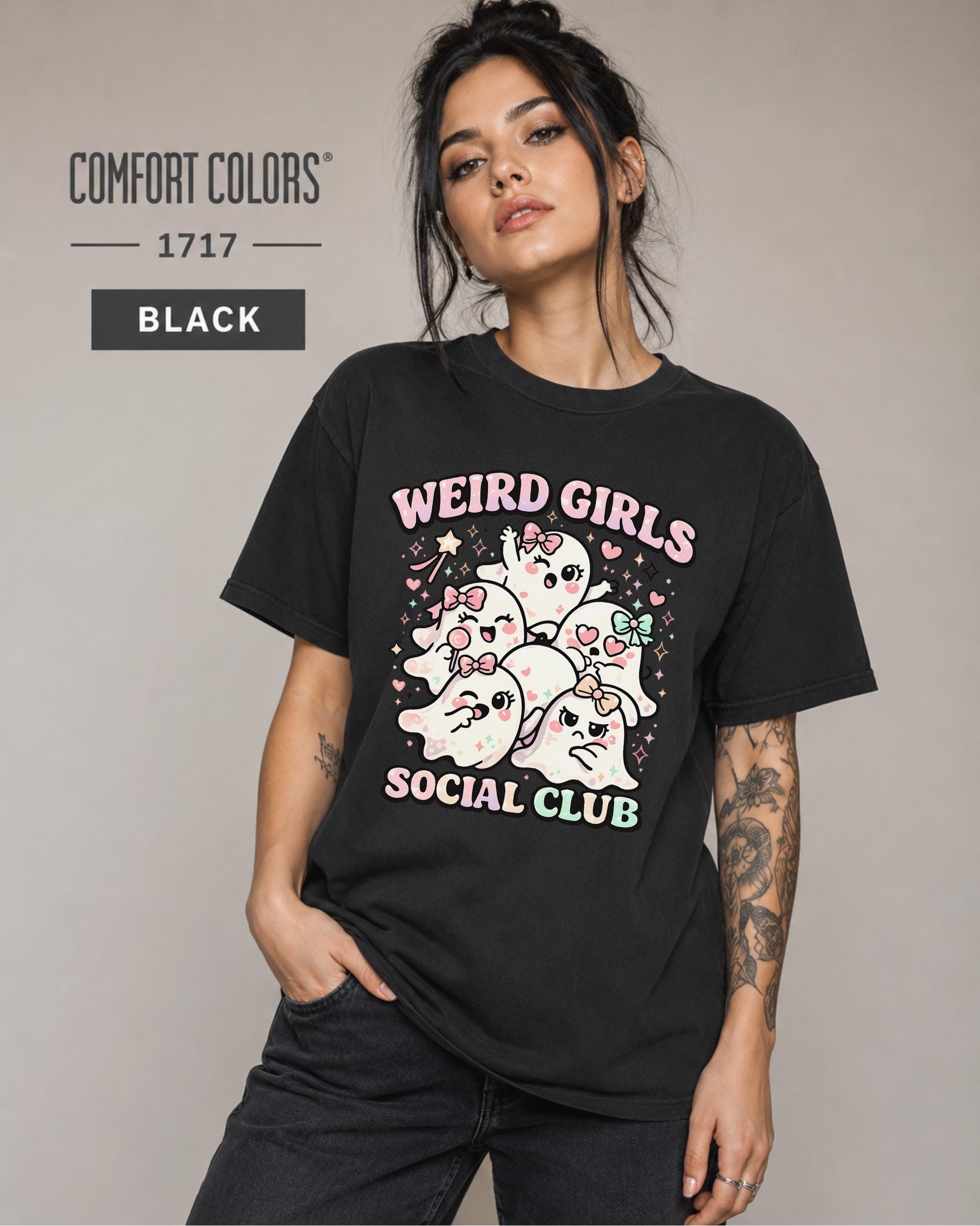 Woman wearing a black Comfort Colors 1717 Weird Girls Social Club shirt with cute pastel ghost characters.
