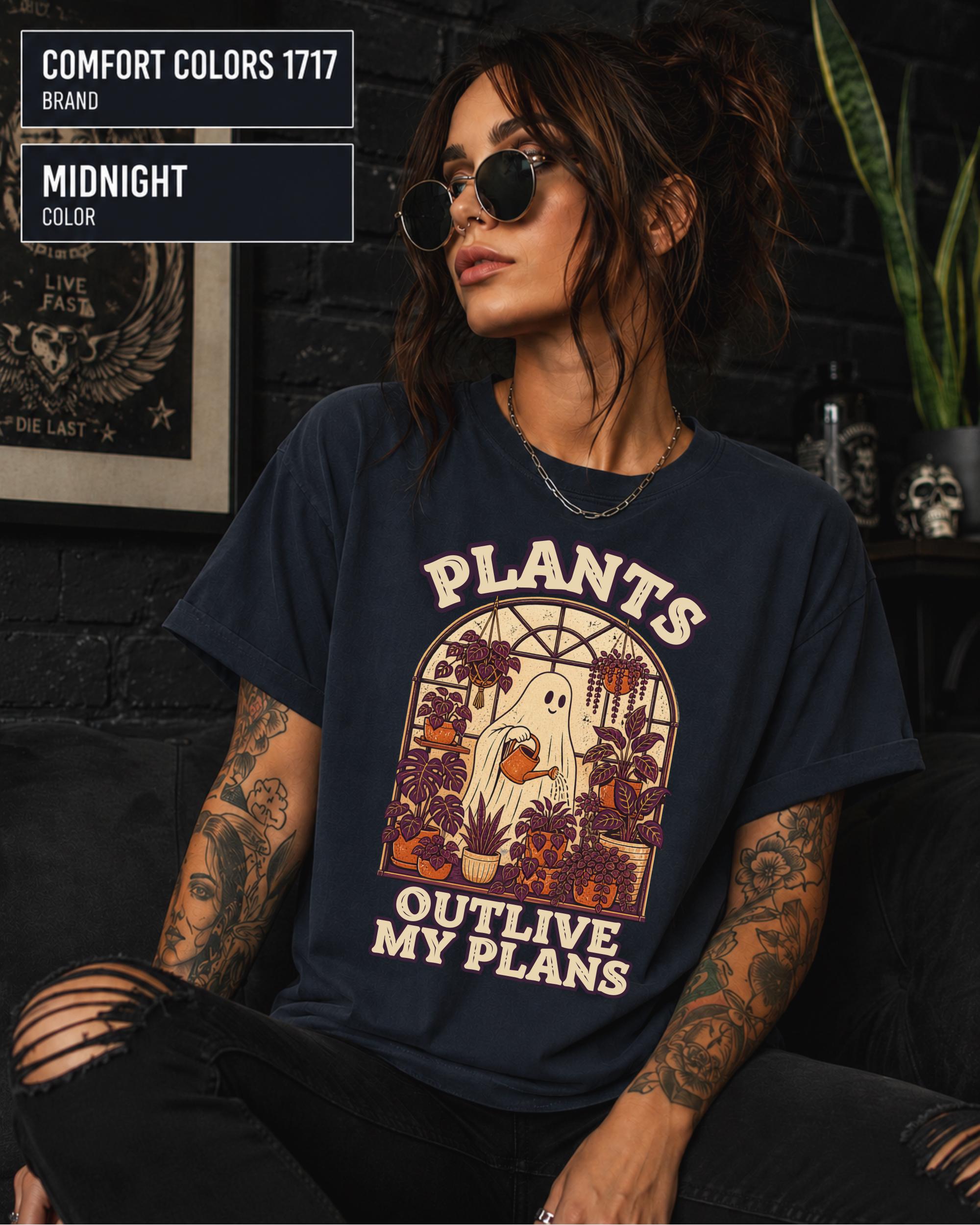 Model wearing Comfort colors tshirt in the color midnight featuring a Retro cream and orange ghost watering purple houseplants inside a greenhouse with the words Plants Outlive My Plans.