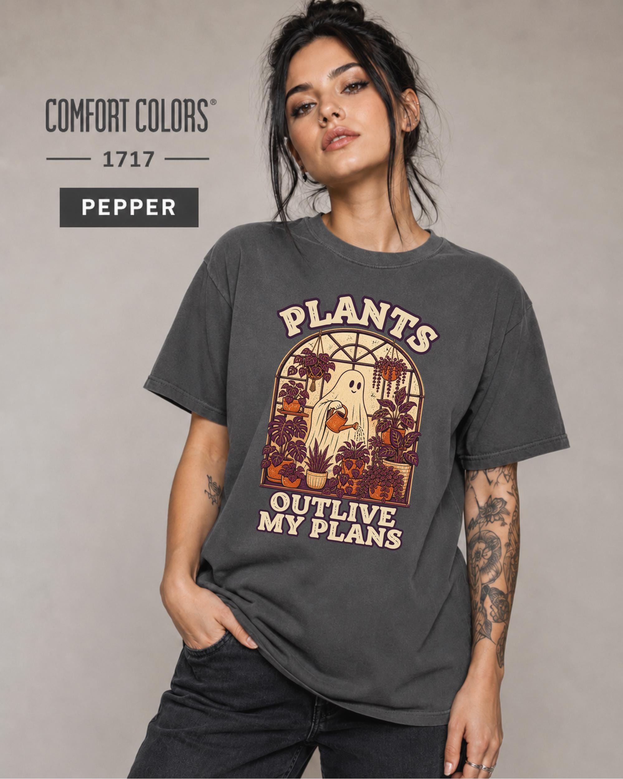 Model wearing Comfort colors tshirt in the color pepper featuring a Retro cream and orange ghost watering purple houseplants inside a greenhouse with the words Plants Outlive My Plans.