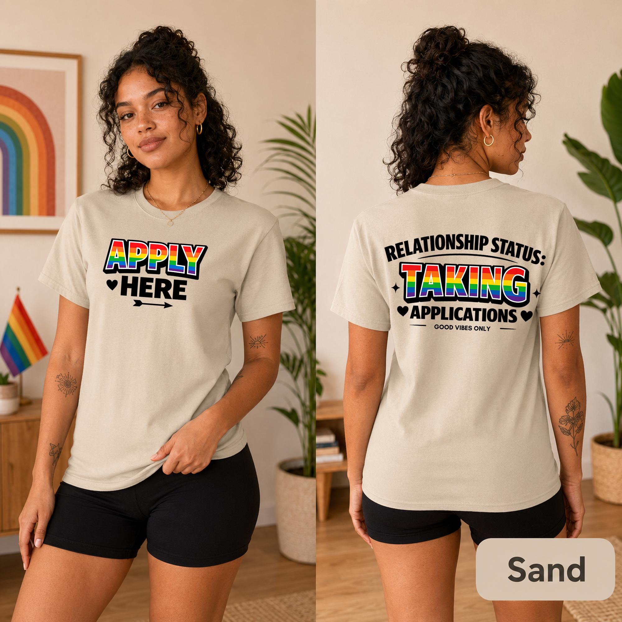 Two-sided LGBTQ graphic tee shown in Sand with bold black typography and colorful accents.