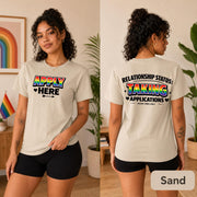 Two-sided LGBTQ graphic tee shown in Sand with bold black typography and colorful accents.