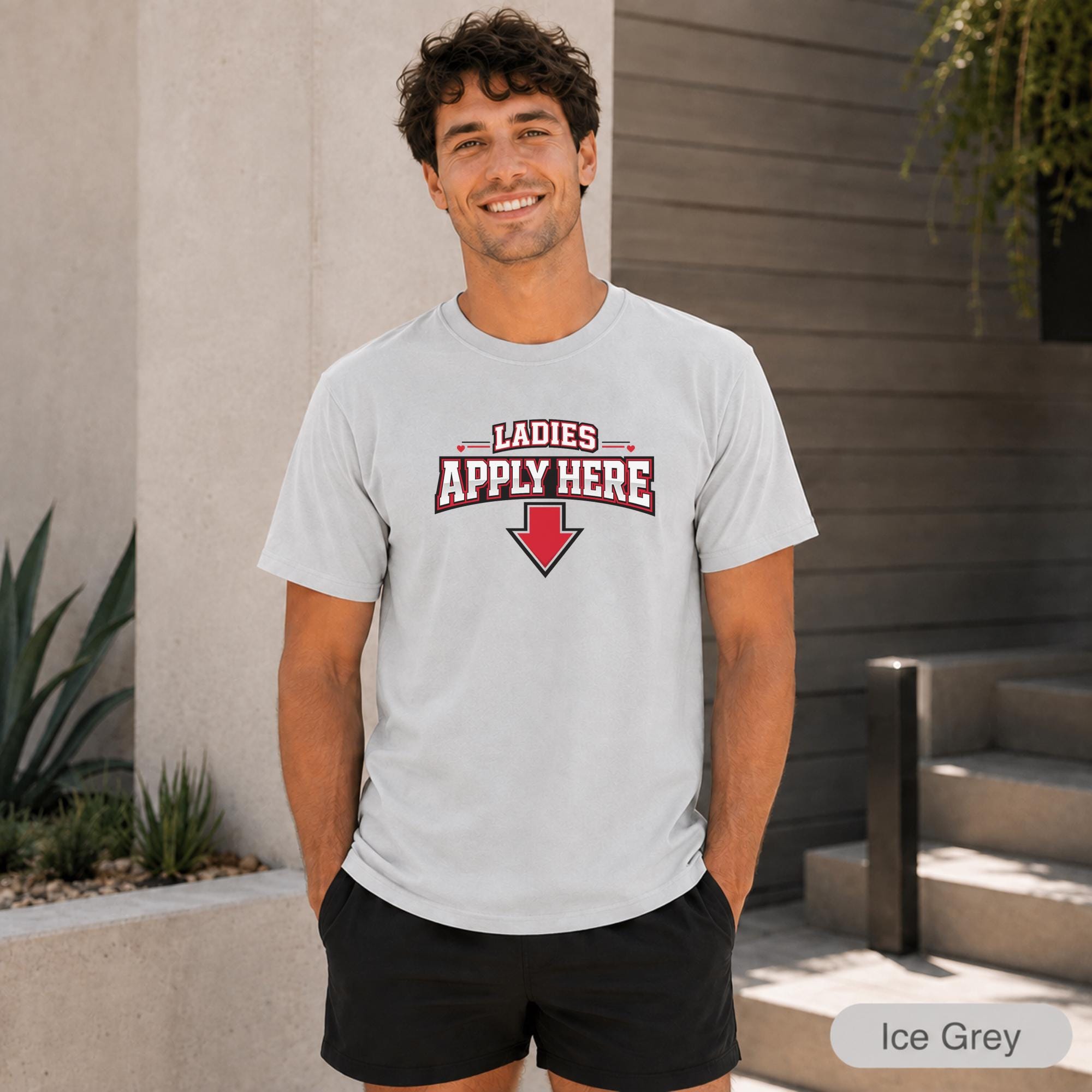 Two-sided single guy shirt displayed outdoors against a modern home background.
