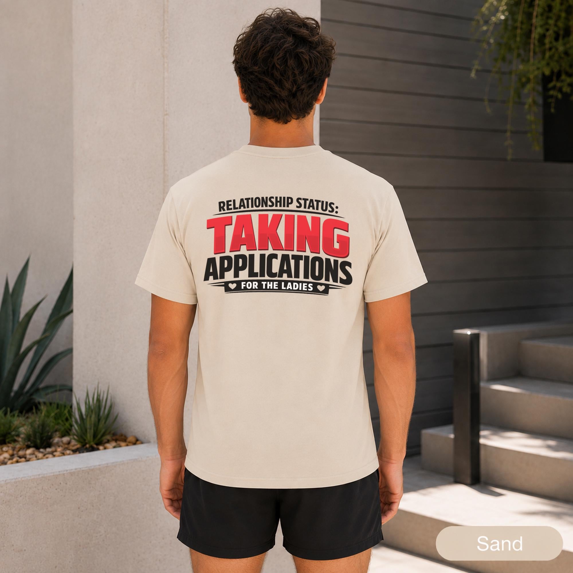 Male model wearing a bold front and back graphic tee with black athletic shorts.