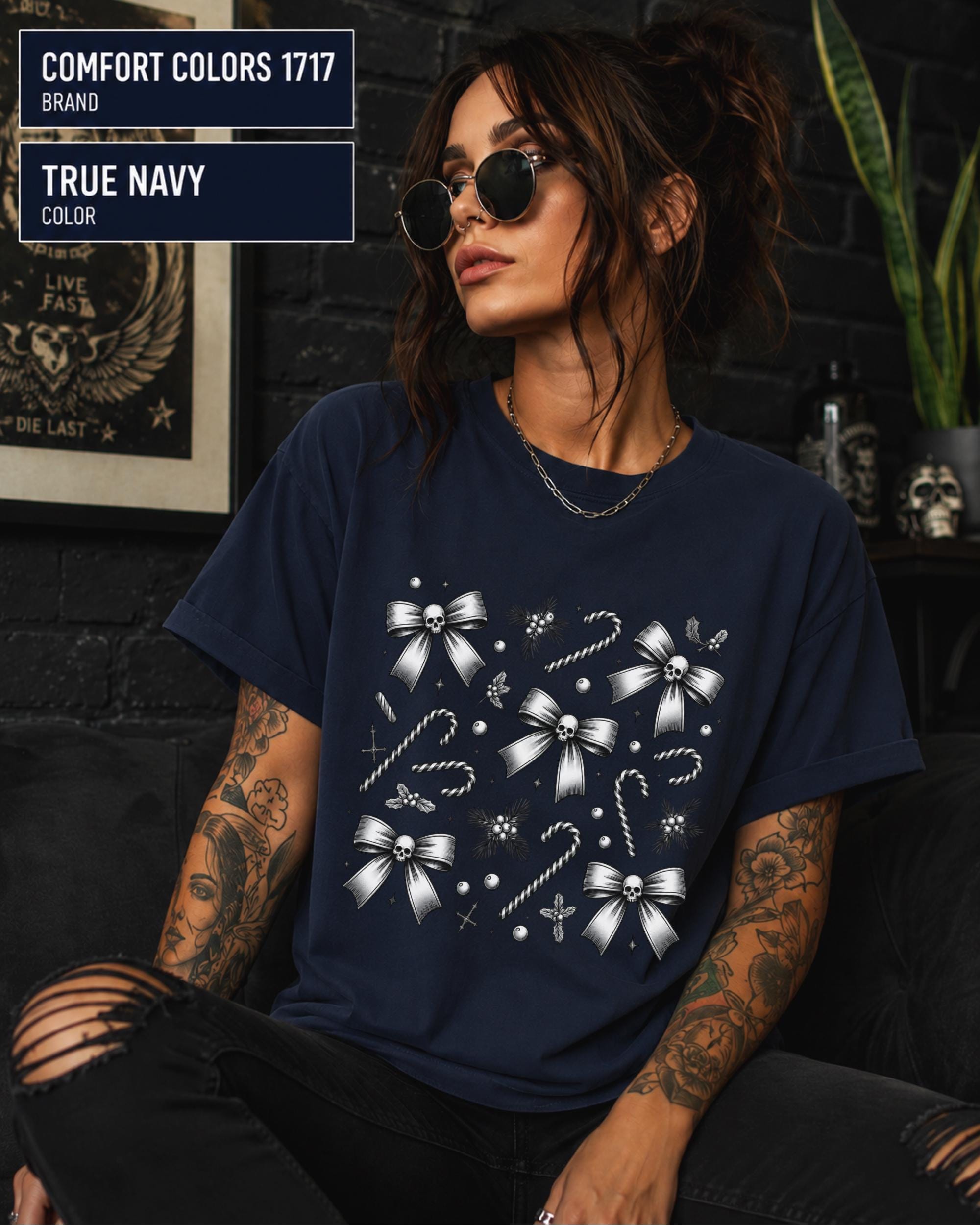 Dark coquette holiday tee featuring silver bows, tiny skulls, holly, pearls, and striped candy canes.