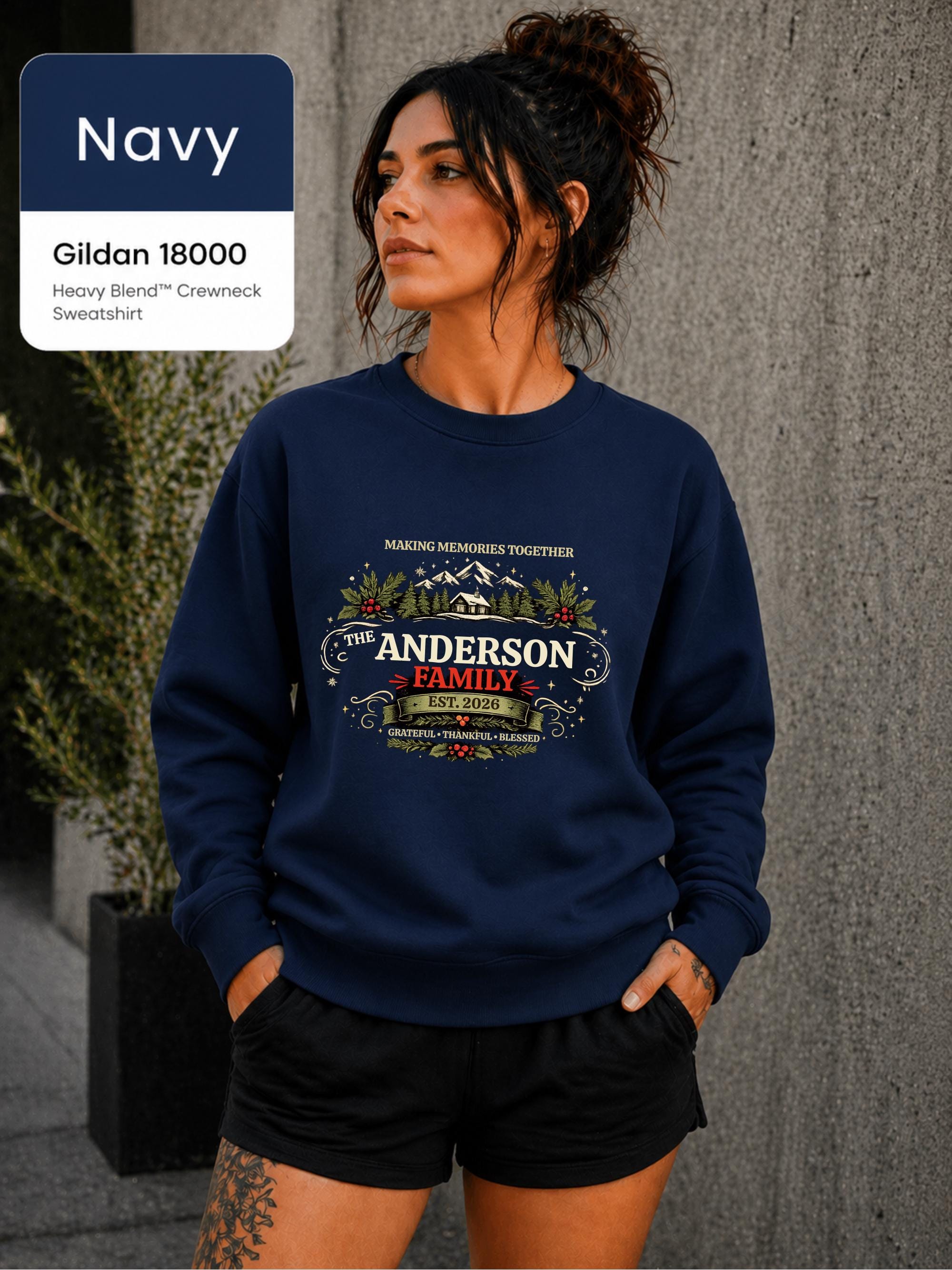 Cozy navy holiday pullover with custom last name, winter landscape, and festive greenery.