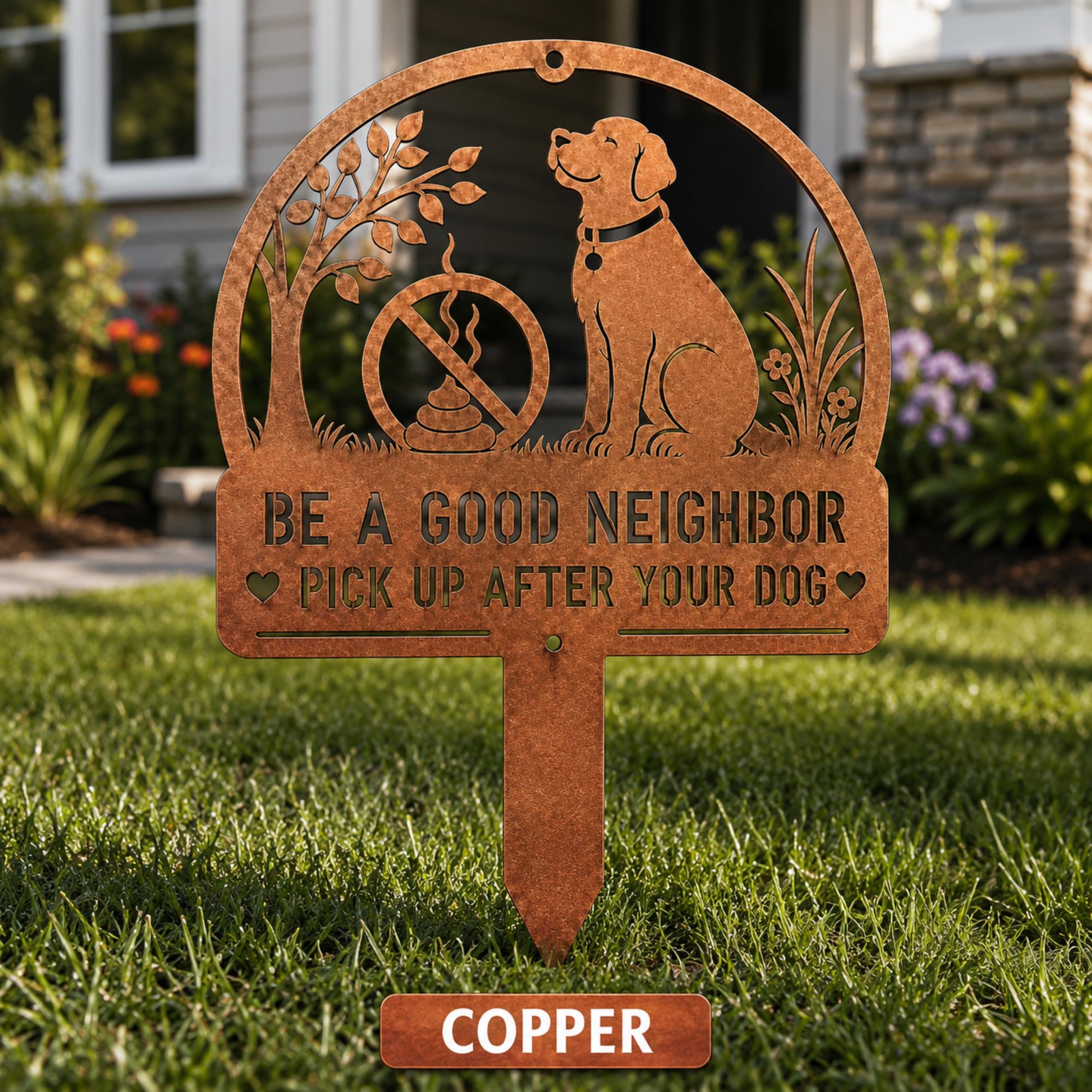 Copper metal yard stake sign with dog silhouette and the text Be a Good Neighbor Pick Up After Your Dog displayed on a front lawn.