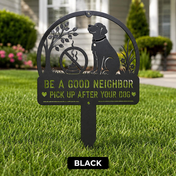 Black metal yard stake sign with dog silhouette and the text Be a Good Neighbor Pick Up After Your Dog displayed on a front lawn.