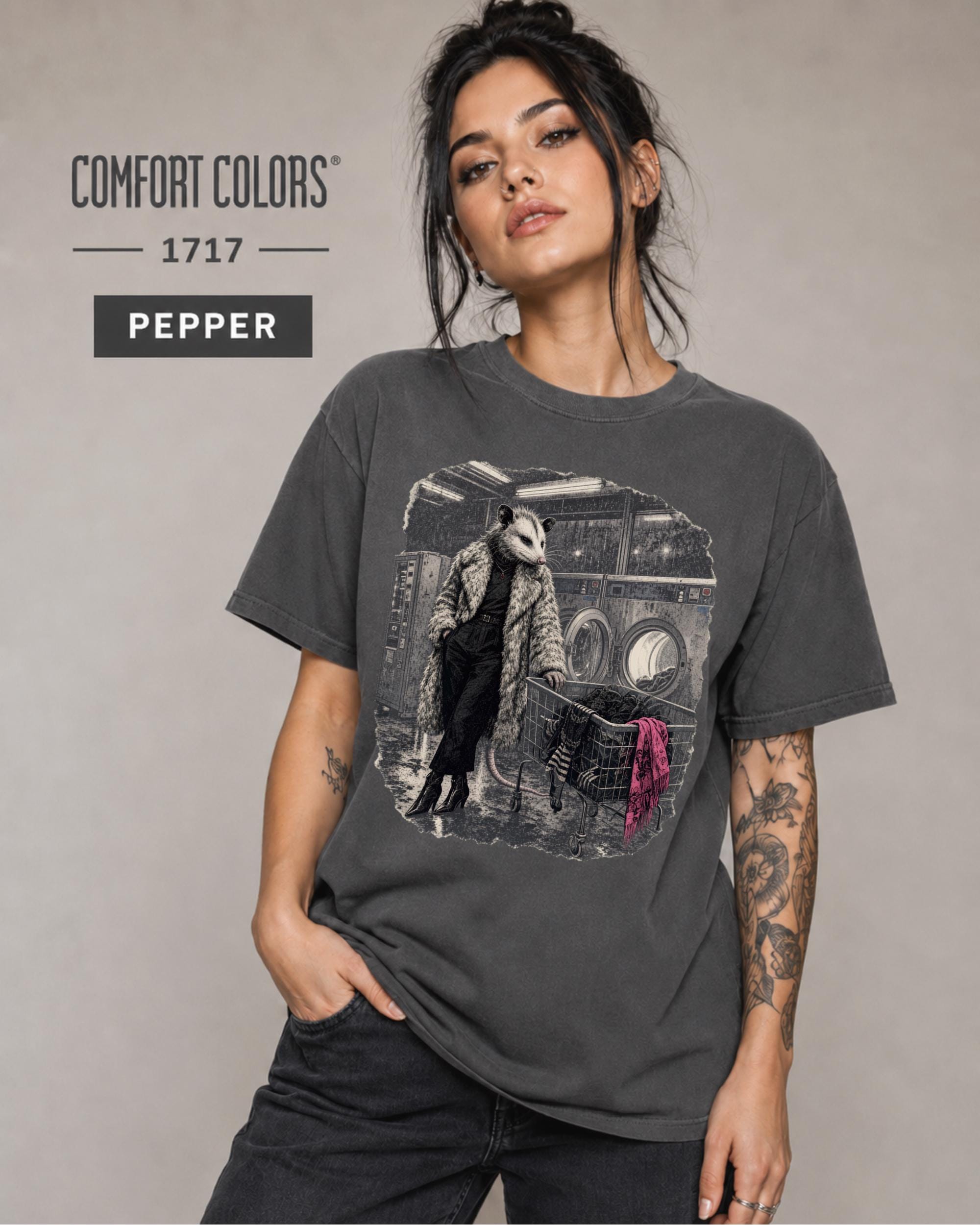 Woman wearing a Pepper Comfort Colors 1717 shirt featuring a stylish opossum inside a vintage laundromat.