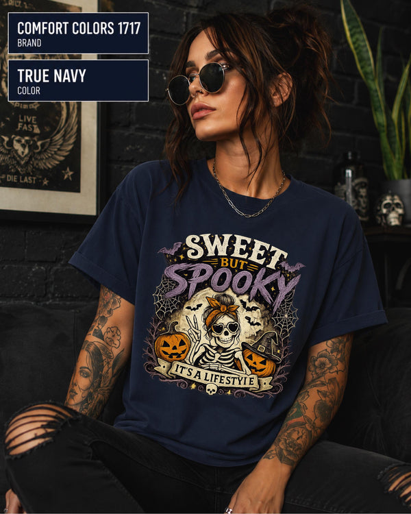 Vintage Halloween graphic tee with skeleton, sunglasses, bow, pumpkins, bats, and spiderwebs.