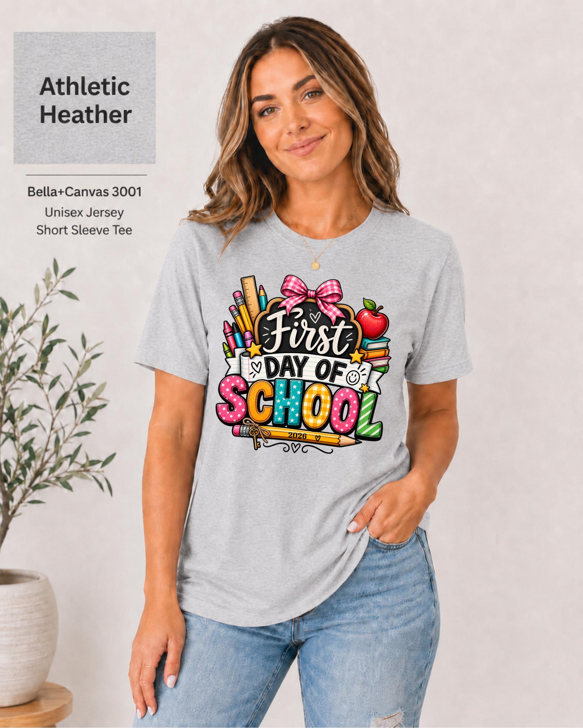 Woman wearing an Athletic Heather Bella+Canvas 3001 personalized First Day of School shirt with customizable teacher name and year, colorful pencils, crayons, books, apple, and pink bow design.