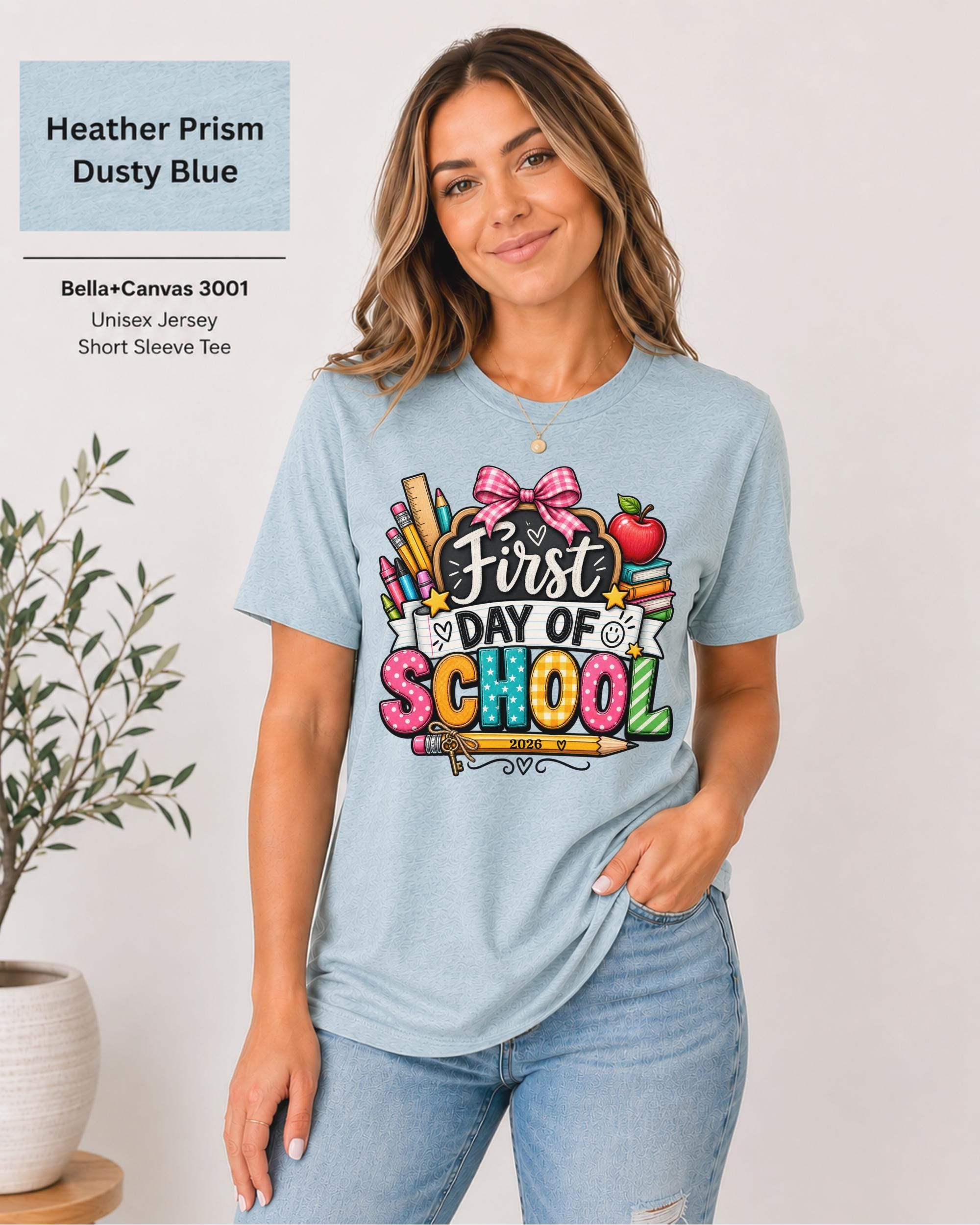 Woman wearing an Heather Prism Dusty Blue Bella+Canvas 3001 personalized First Day of School shirt with customizable teacher name and year, colorful pencils, crayons, books, apple, and pink bow design.
