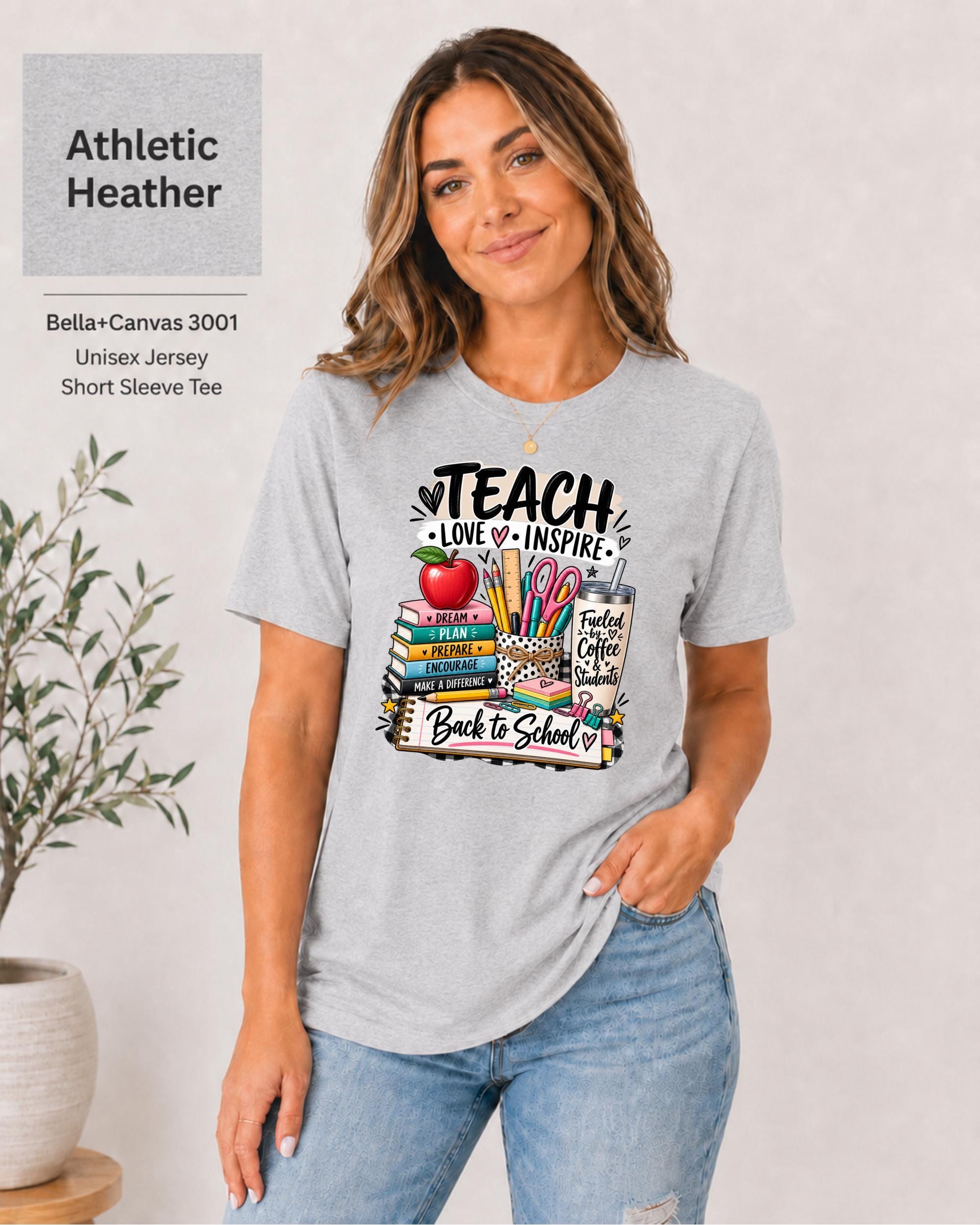 Teacher graphic tee featuring stacked books, pencils, scissors, apple, and coffee tumbler.