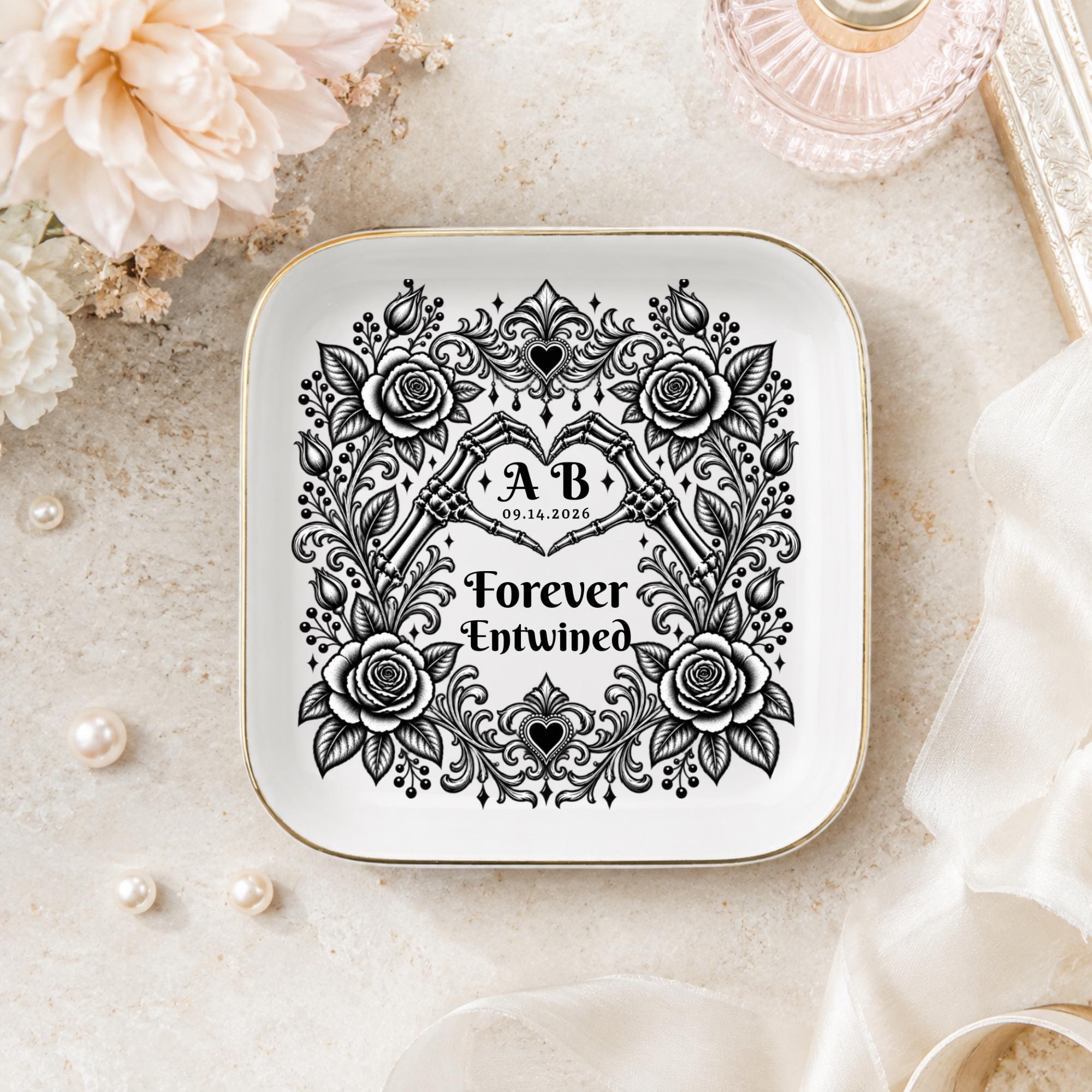 Alternative wedding ring tray with black floral artwork, skeleton hands forming a heart, and custom couple details.