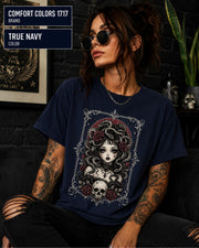 Woman wearing a True Navy Comfort Colors 1717 T-shirt featuring a gothic Medusa-inspired woman with snakes, dark roses, ornate framing, and a skull design.