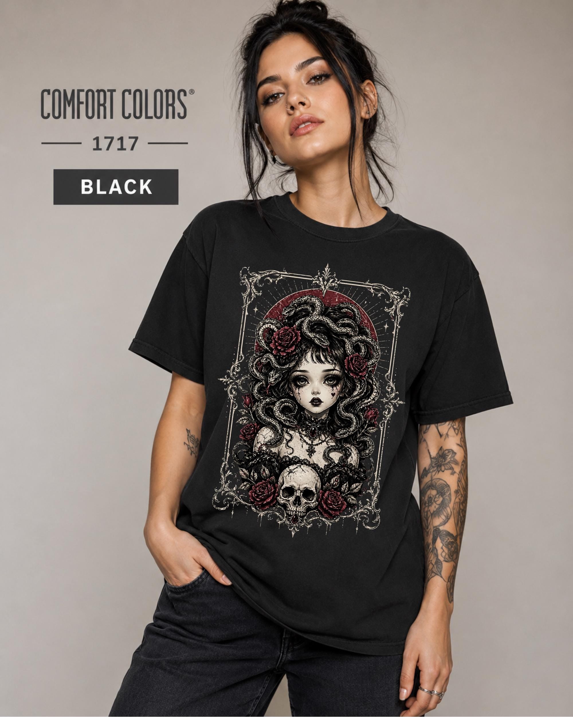 Woman wearing a Black Comfort Colors 1717 T-shirt featuring a gothic Medusa-inspired woman with snakes, dark roses, ornate framing, and a skull design.