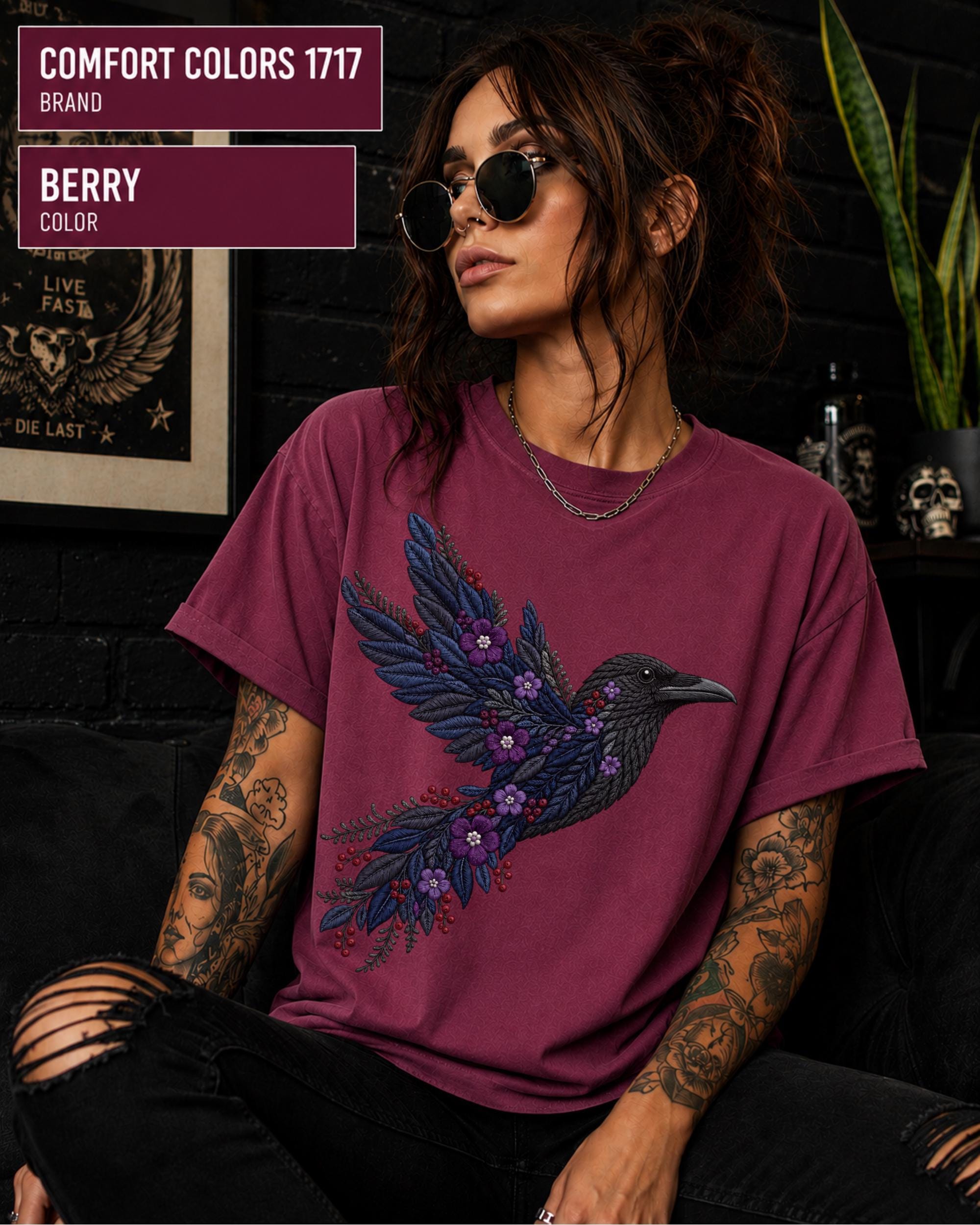 Berry Comfort Colors 1717 t-shirt featuring a black raven graphic with purple flowers and blue feather details in a gothic botanical style.