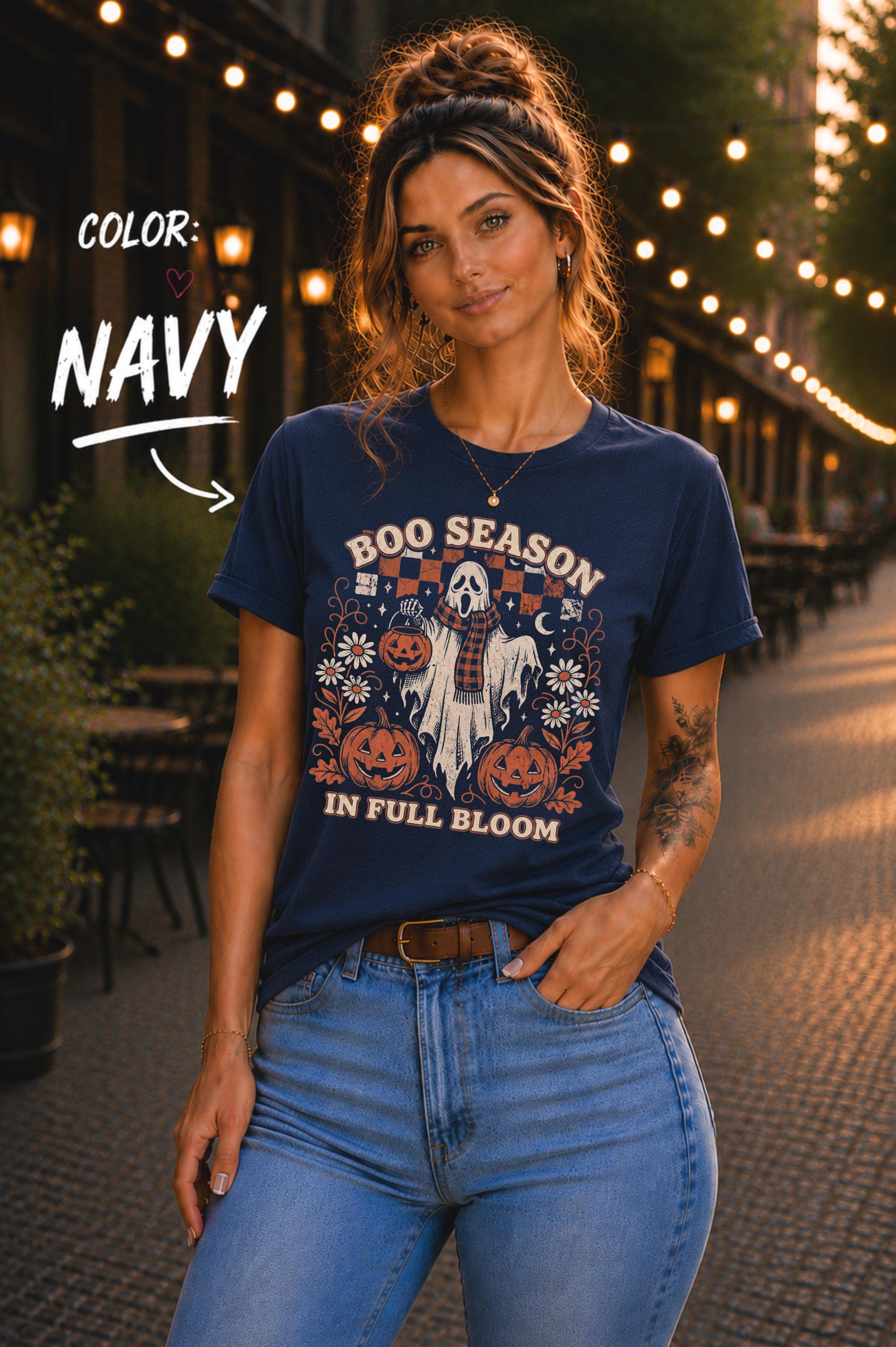 Cute ghost T-shirt styled with blue jeans on a warmly lit outdoor walkway.