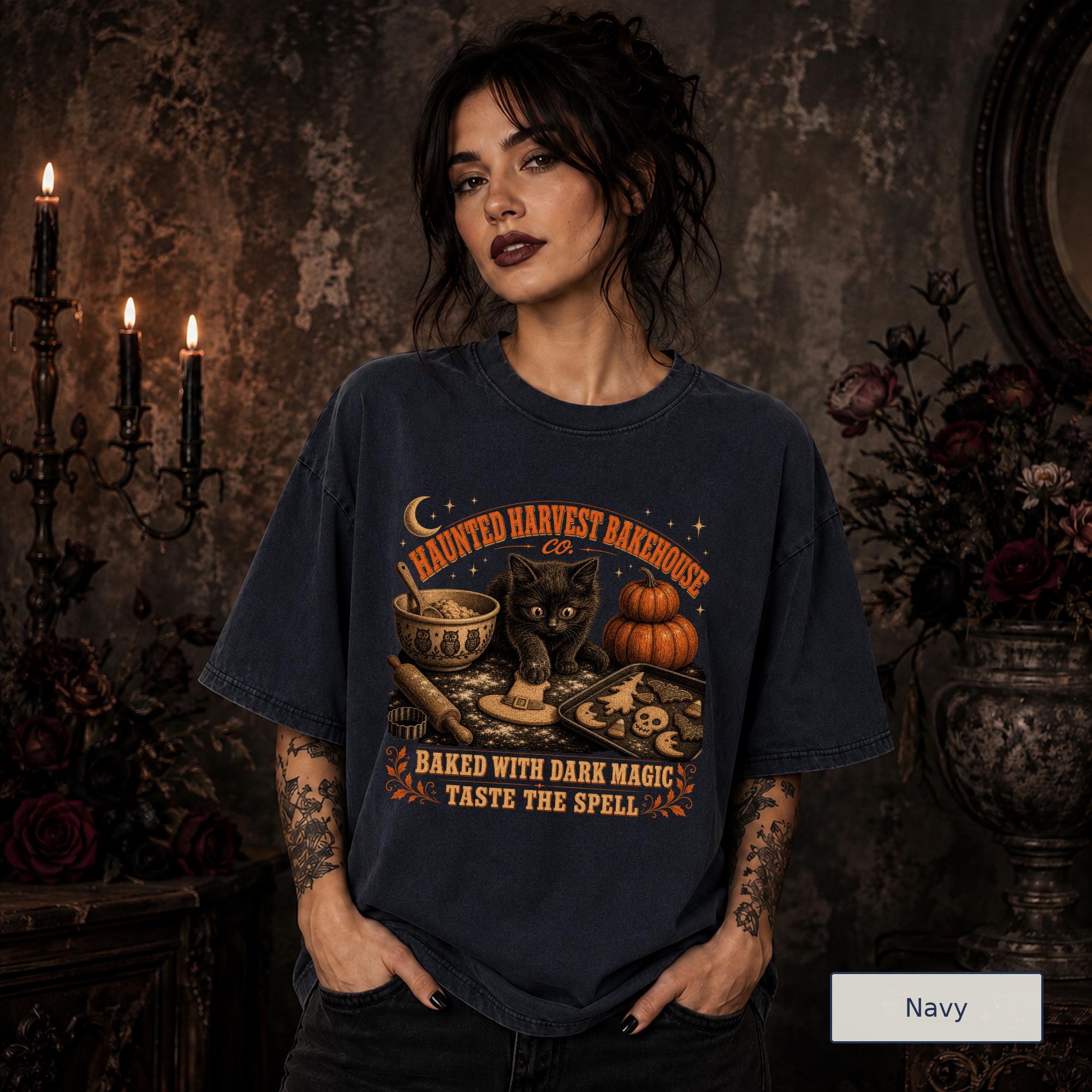 Spooky fall graphic tee featuring a black kitten, pumpkins, baking bowl, and Halloween cookies.