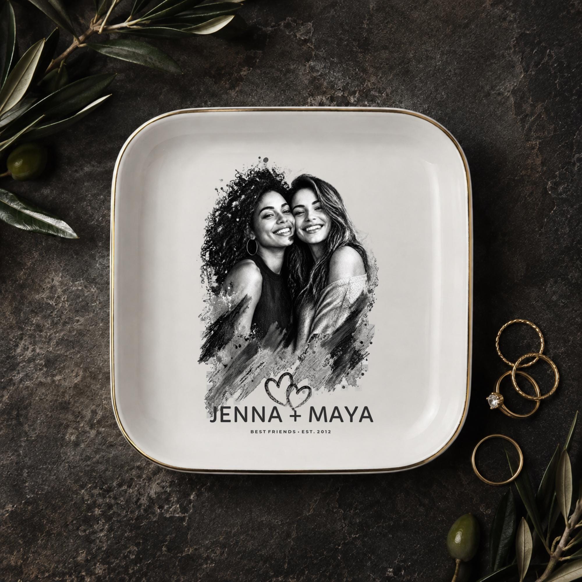 Personalized best friend jewelry dish featuring a custom black-and-white photo, two names, established year, heart design, and gold rim.