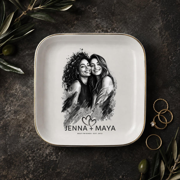 Personalized best friend jewelry dish featuring a custom black-and-white photo, two names, established year, heart design, and gold rim.