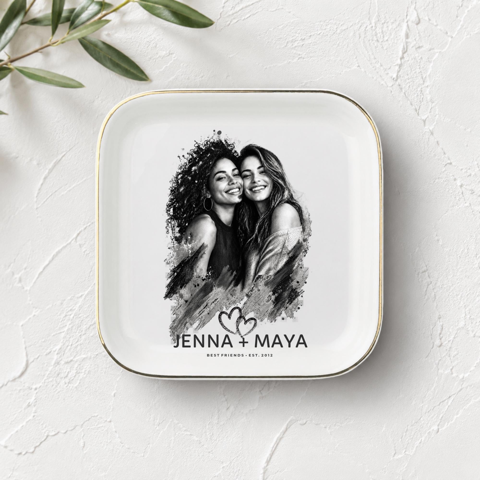 Personalized best friend jewelry dish featuring a custom black-and-white photo, two names, established year, heart design, and gold rim.